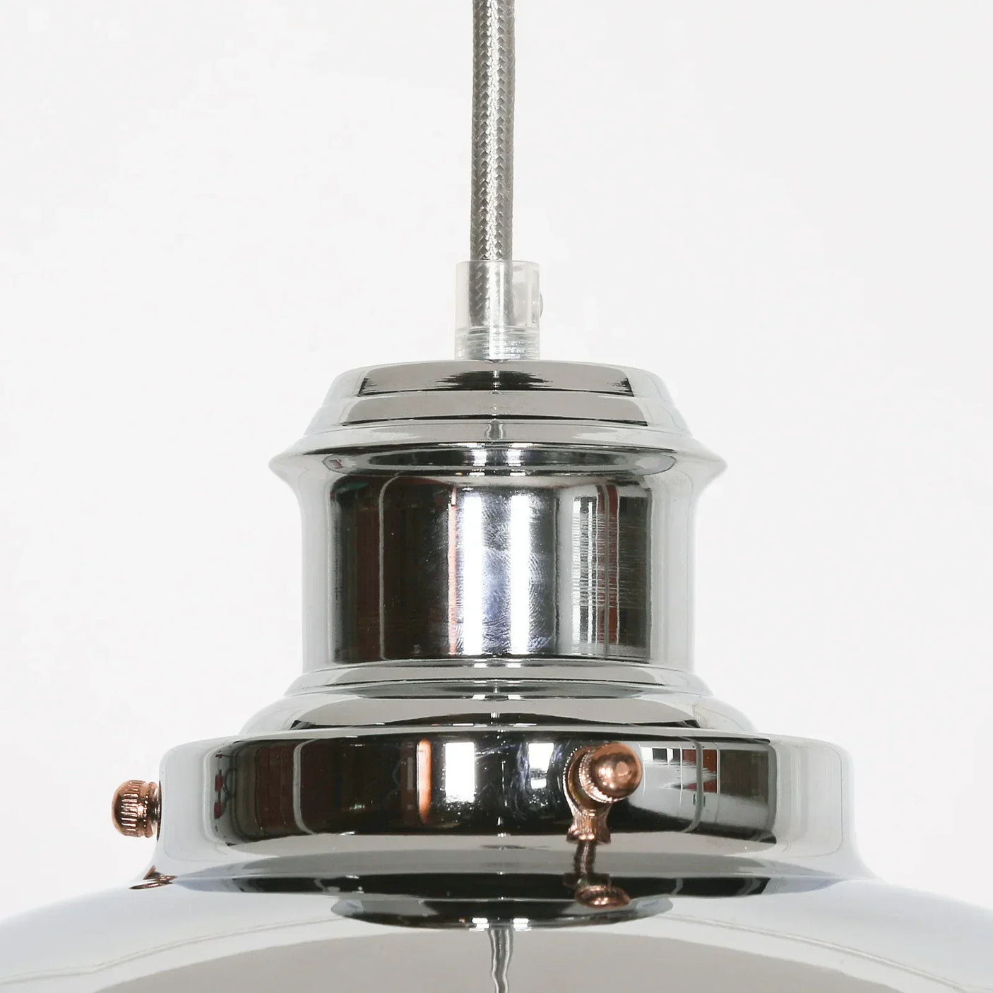 Close-up of chrome pendant light fixture with metallic finish and industrial design details