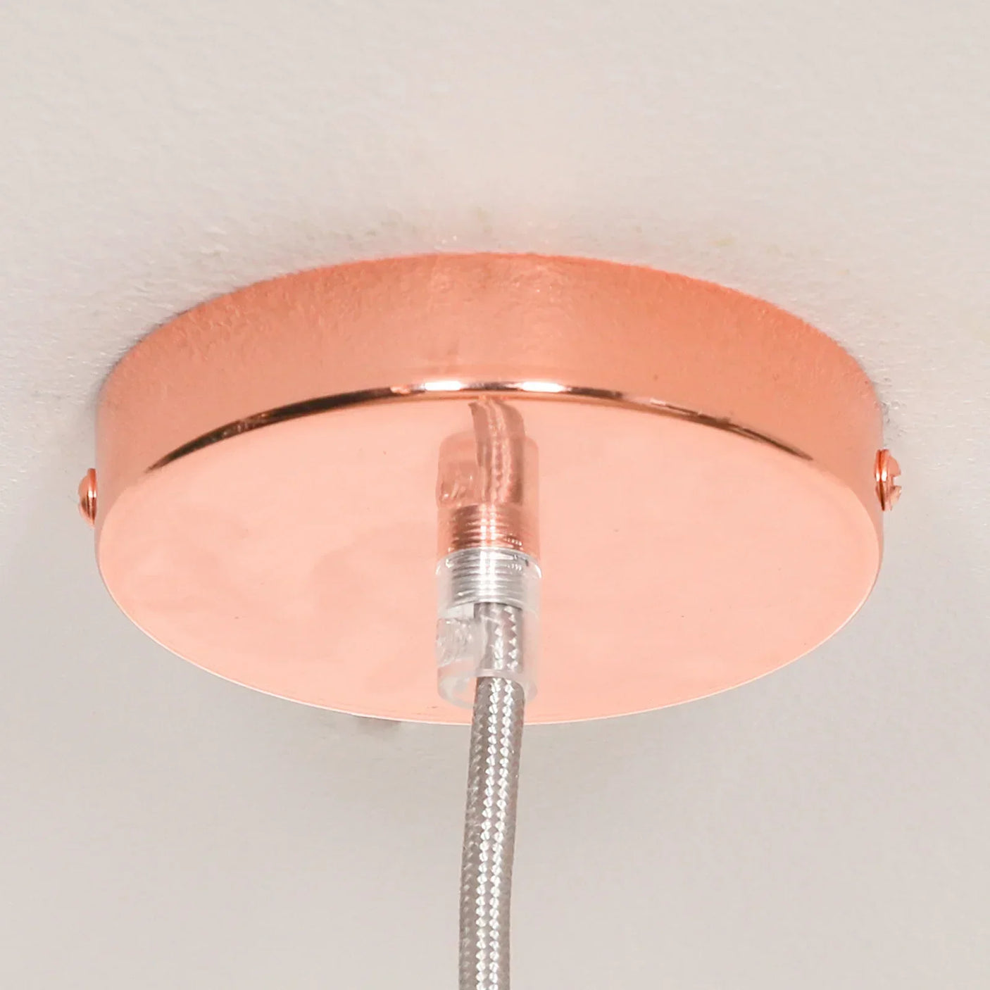 Copper ceiling rose with attached braided pendant light cable