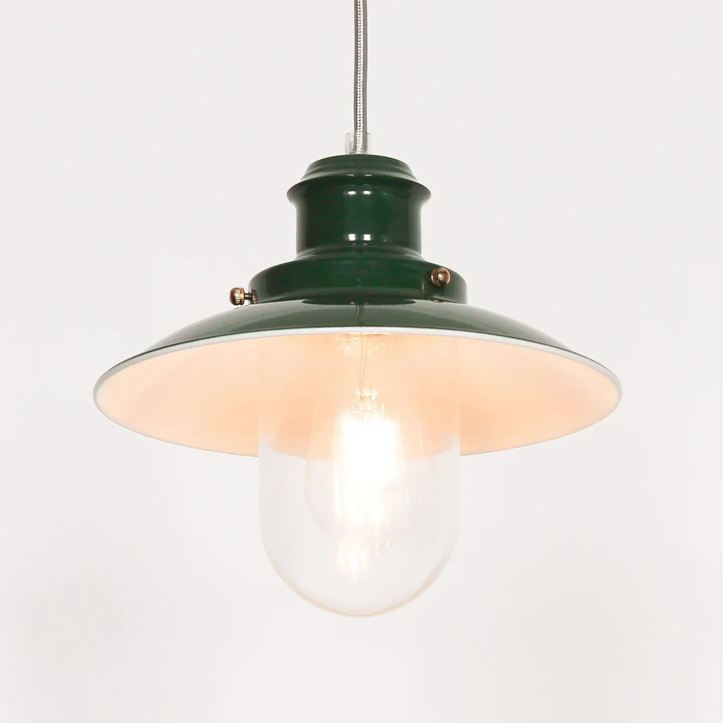 Green metal pendant light with wide shade and clear glass bulb cover