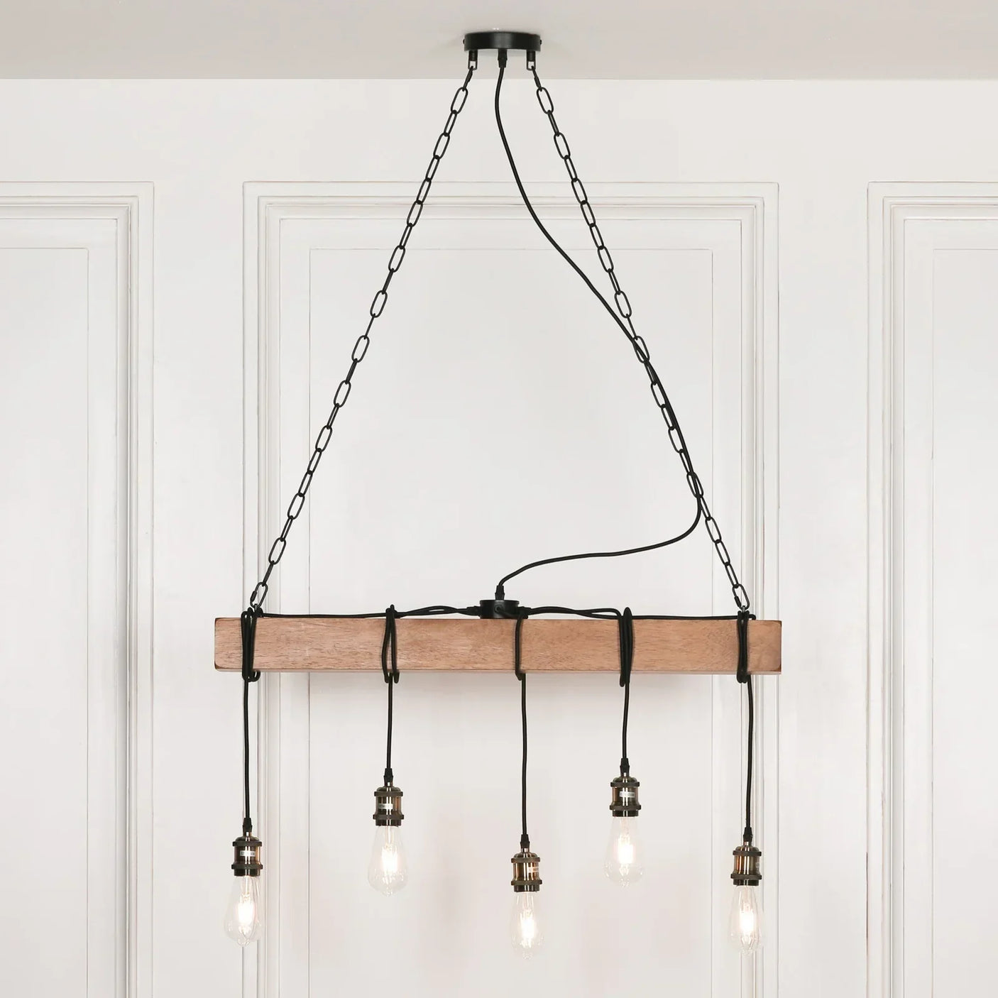 Industrial wood and metal ceiling light fixture with five exposed bulbs and hanging chains