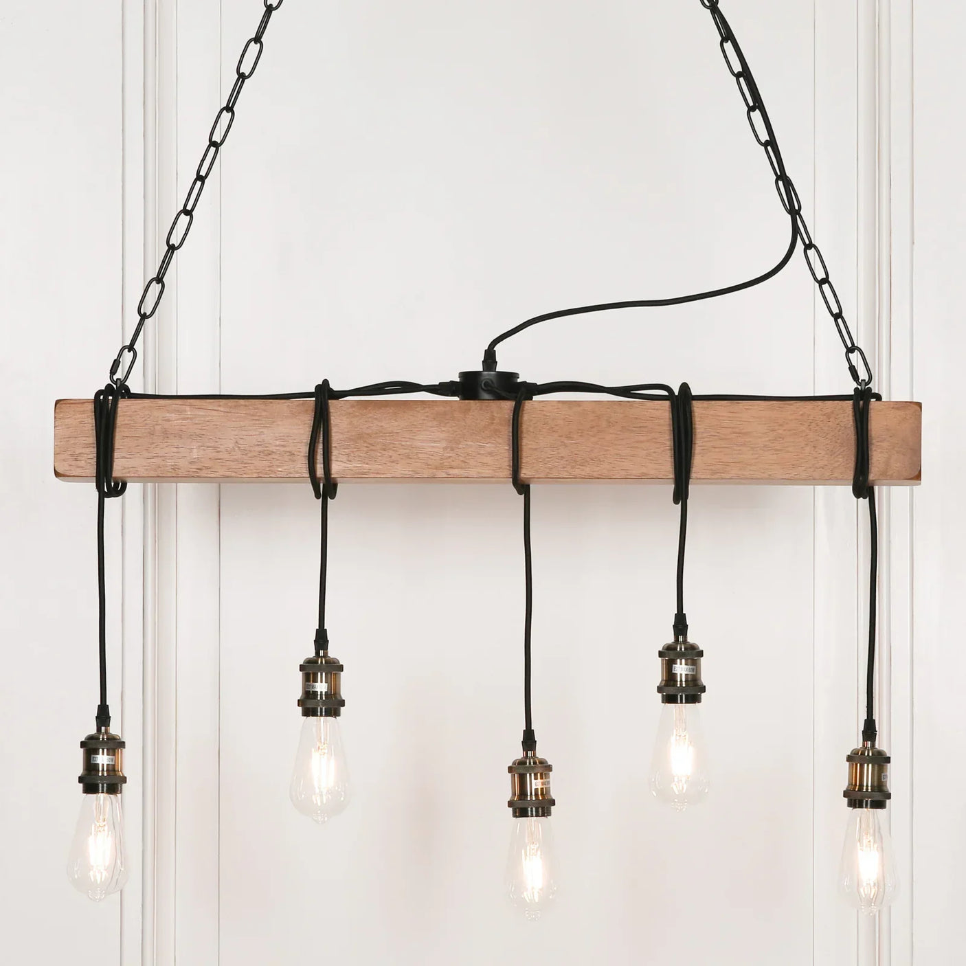 Rectangular wooden pendant light with five hanging exposed bulbs and black cords