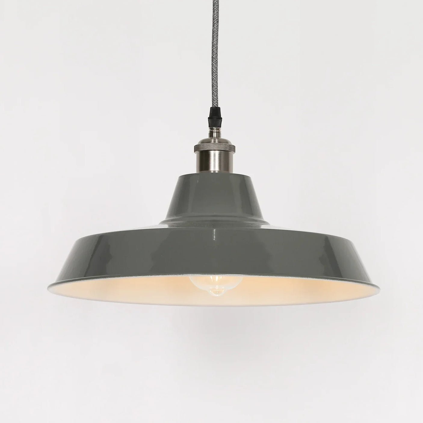 Grey metal pendant ceiling light with exposed bulb and braided cable, modern industrial design