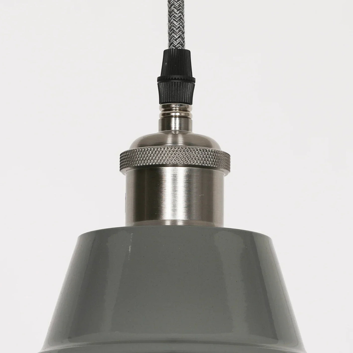 Grey metal pendant light with brushed steel fitting and textured cord close-up