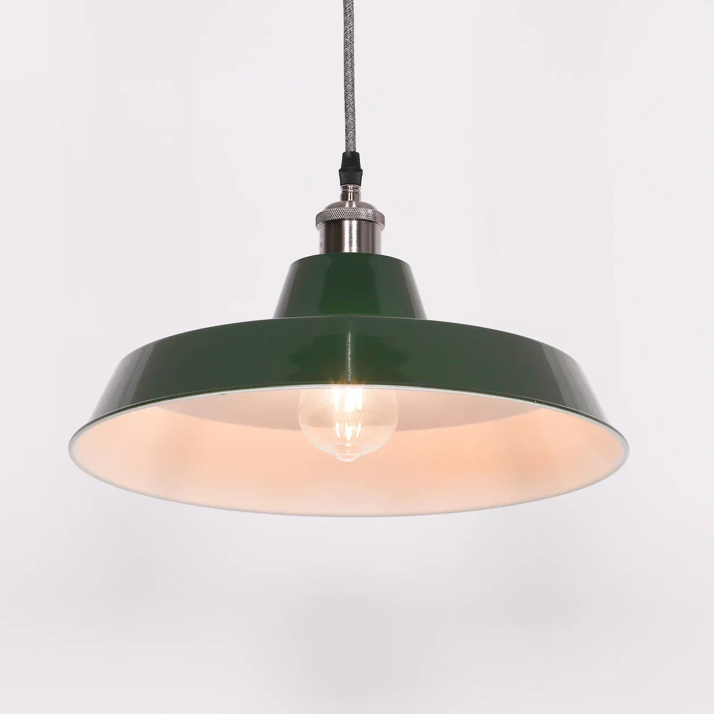 Green metal pendant ceiling light with exposed bulb and braided cord