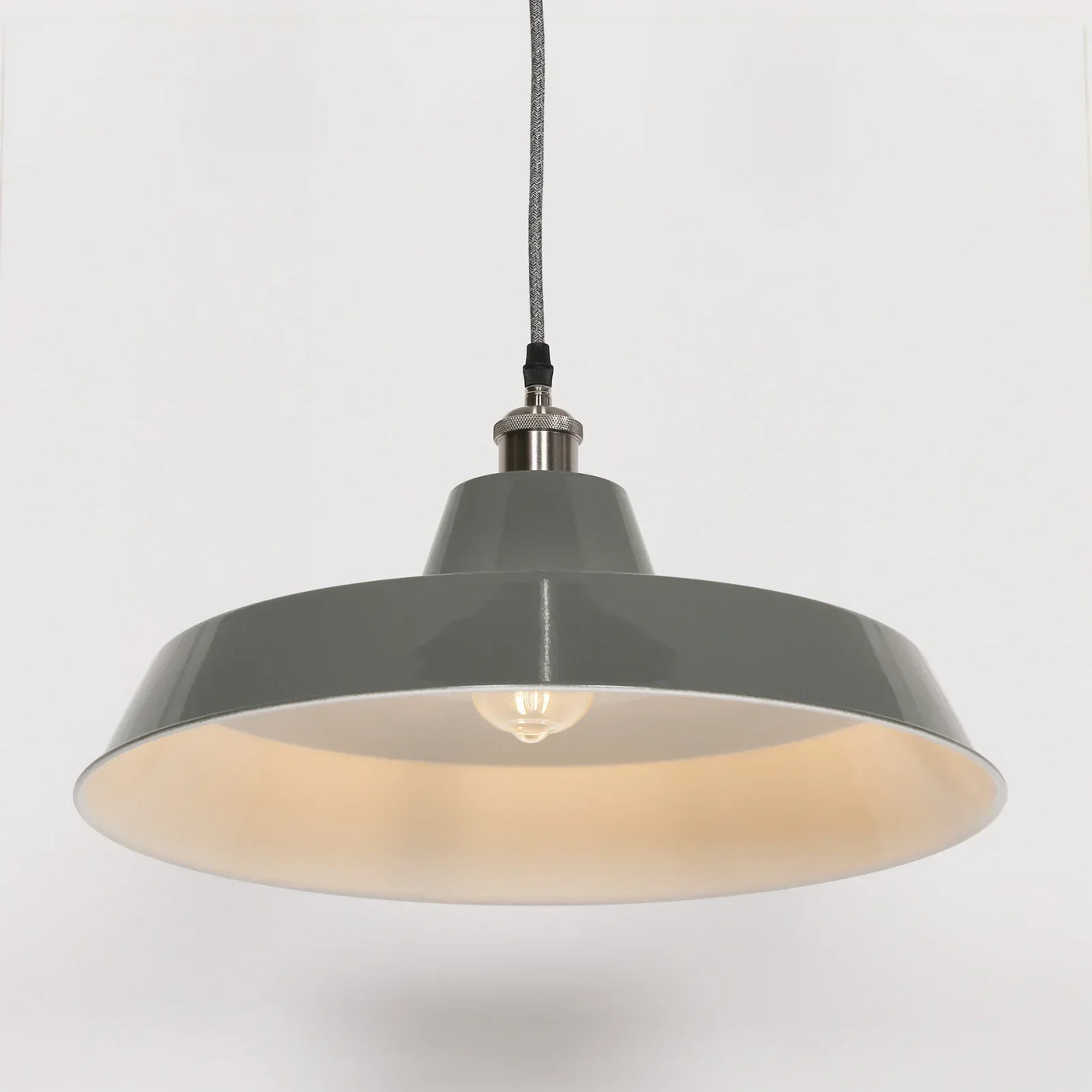 Grey metal pendant ceiling light with exposed bulb and braided cable