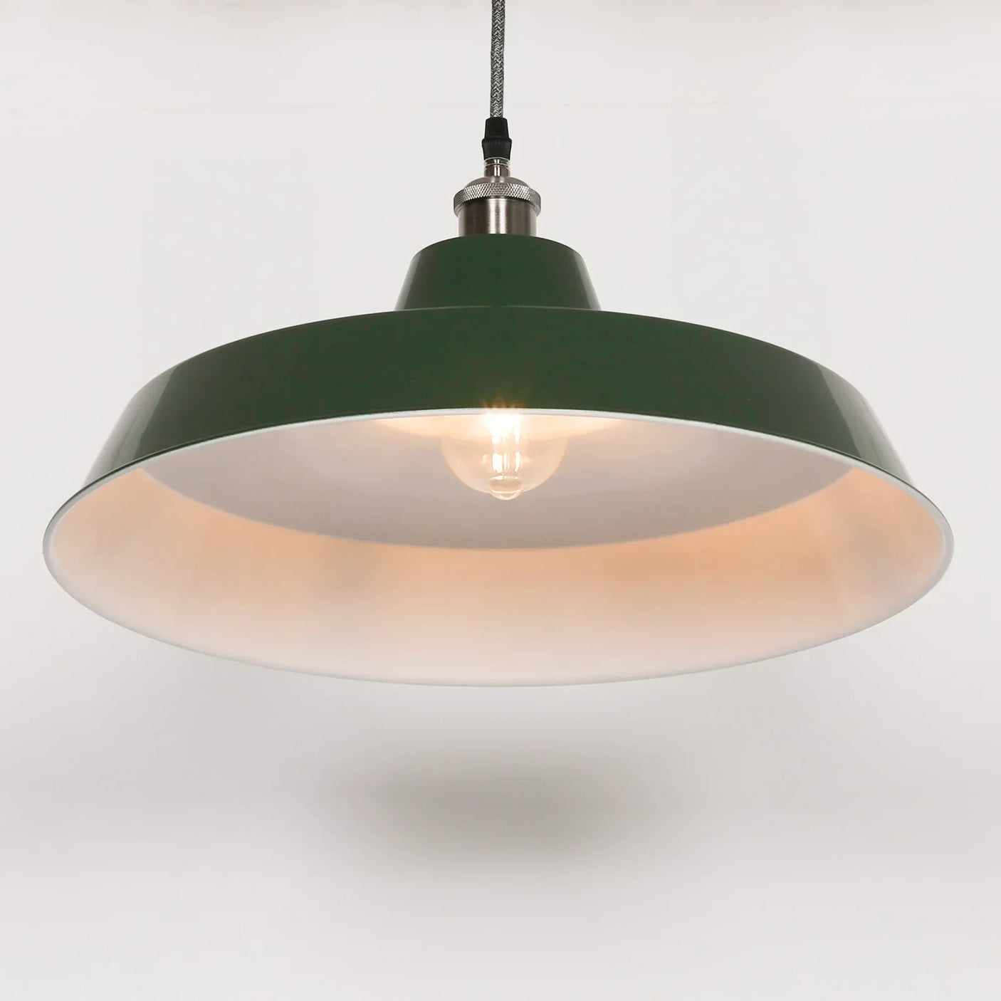Green metal pendant ceiling light with exposed bulb and white inner shade