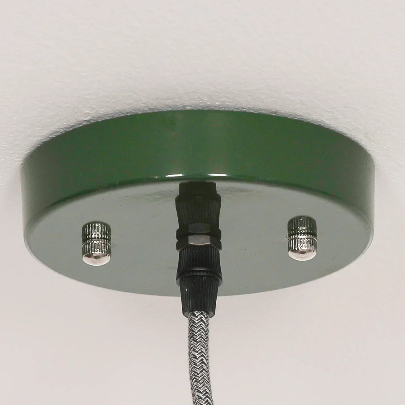 Green metal light fitting ceiling rose with black textile cable and chrome screws