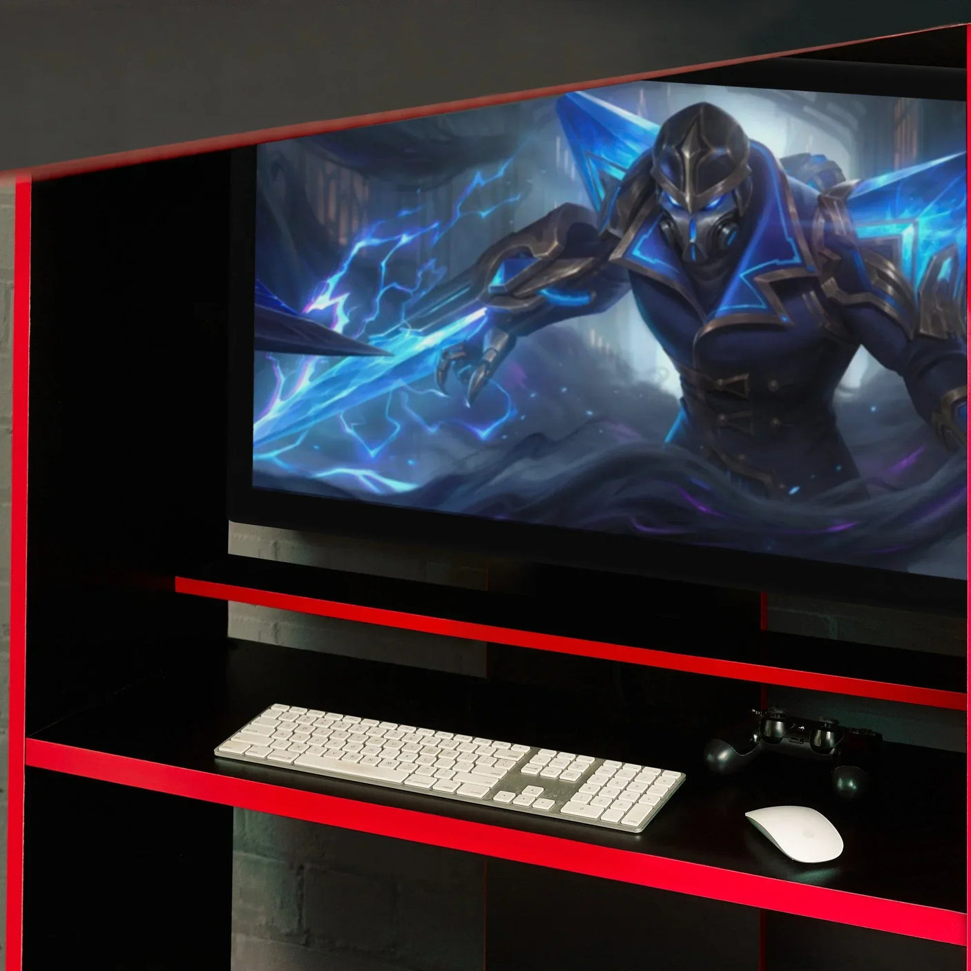 Black and red gaming desk with keyboard, mouse, controller and monitor on display shelf