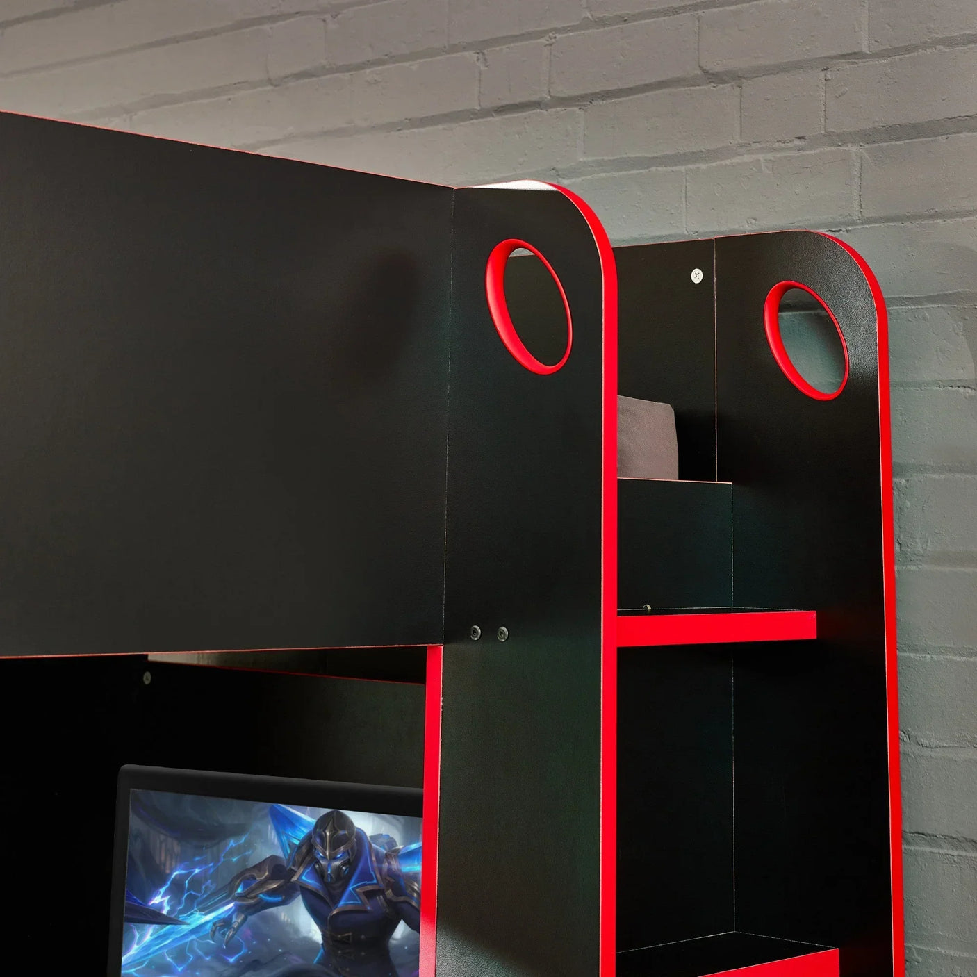 Black and red gaming bunk bed with storage shelves against a grey brick wall