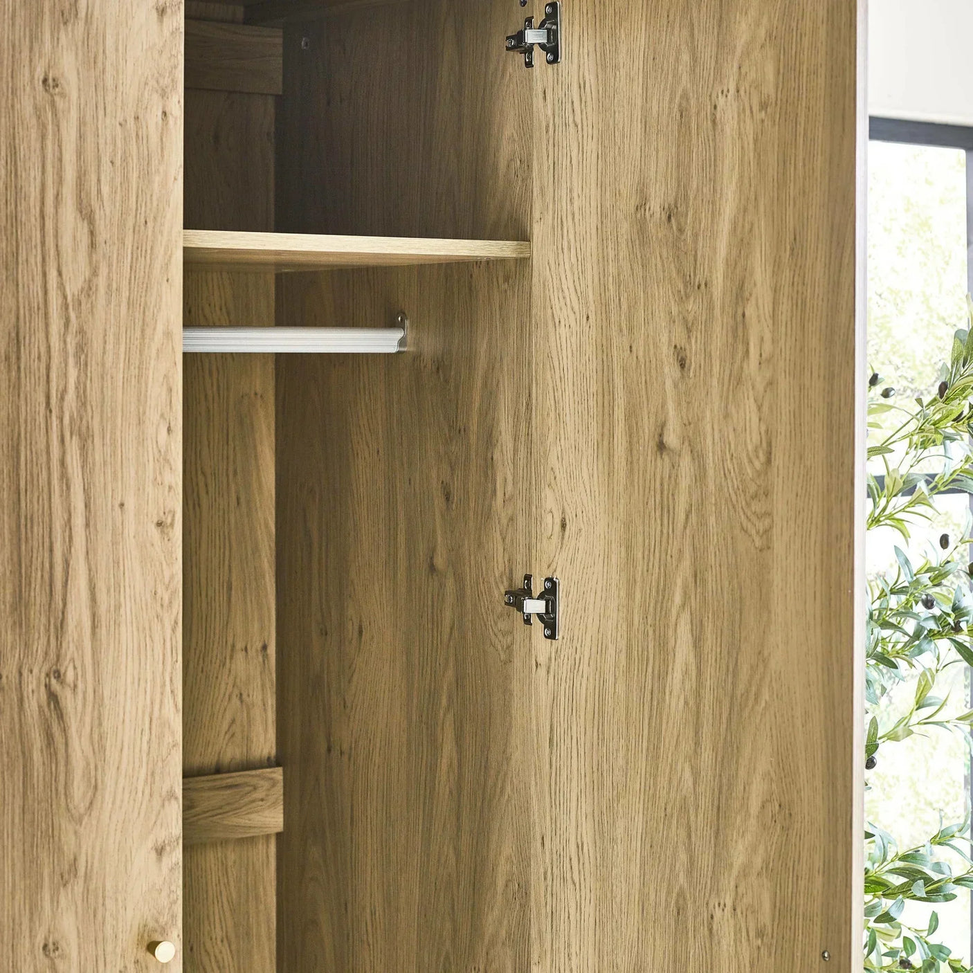 Oak wood wardrobe with hanging rail and shelf, doors open showing interior storage
