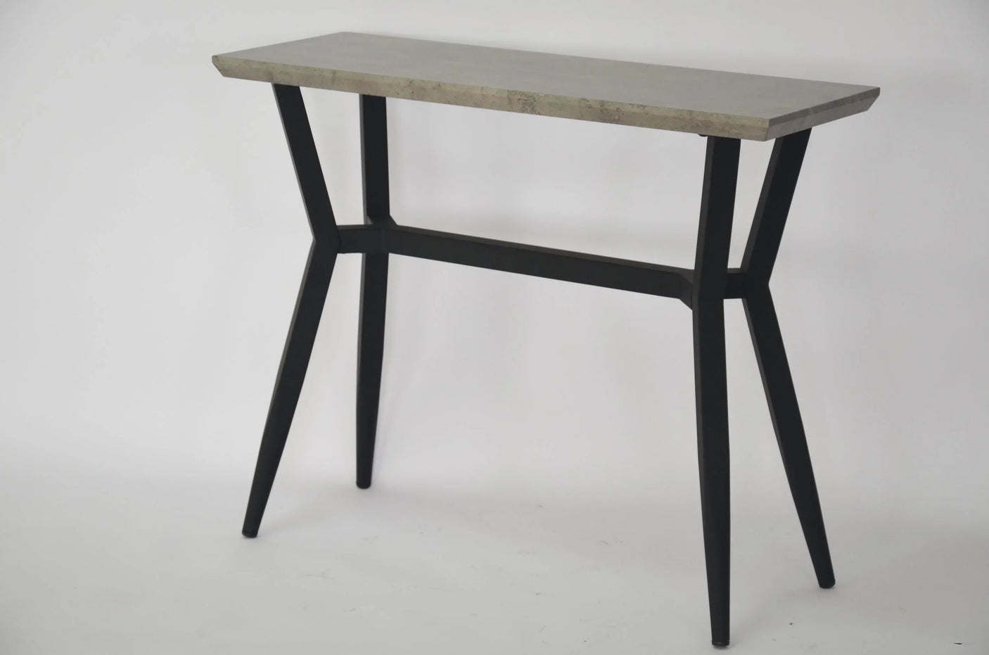Modern console table with grey stone top and black metal frame on white background