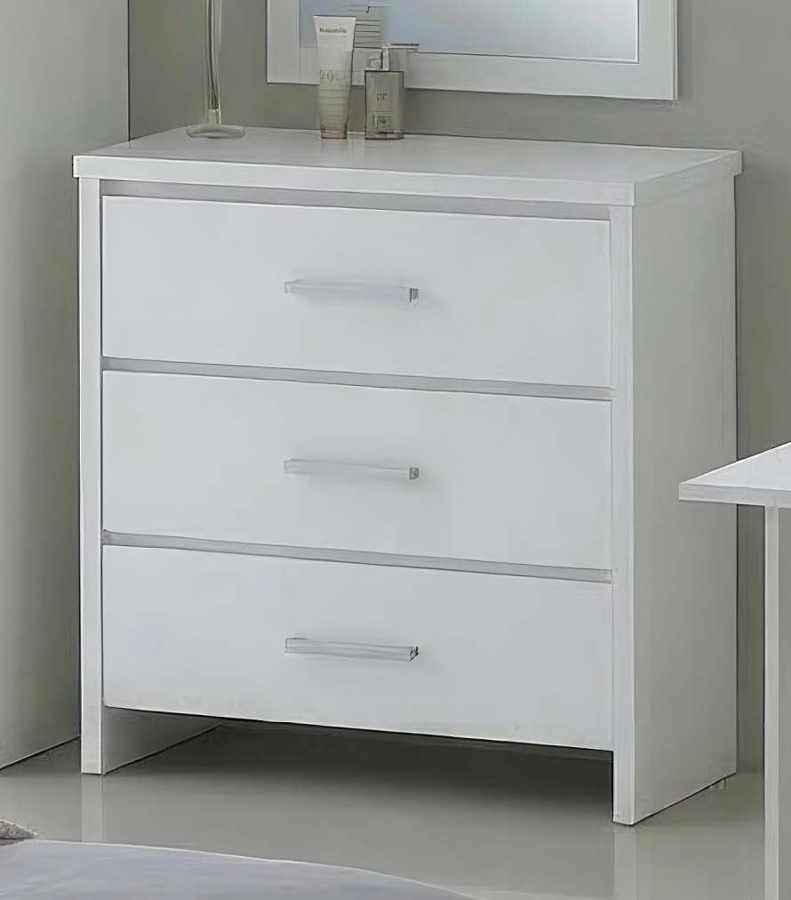 A white three-drawer dresser with slim silver handles, shown in a minimalist bedroom setting with a mirror and bedside table partially visible.