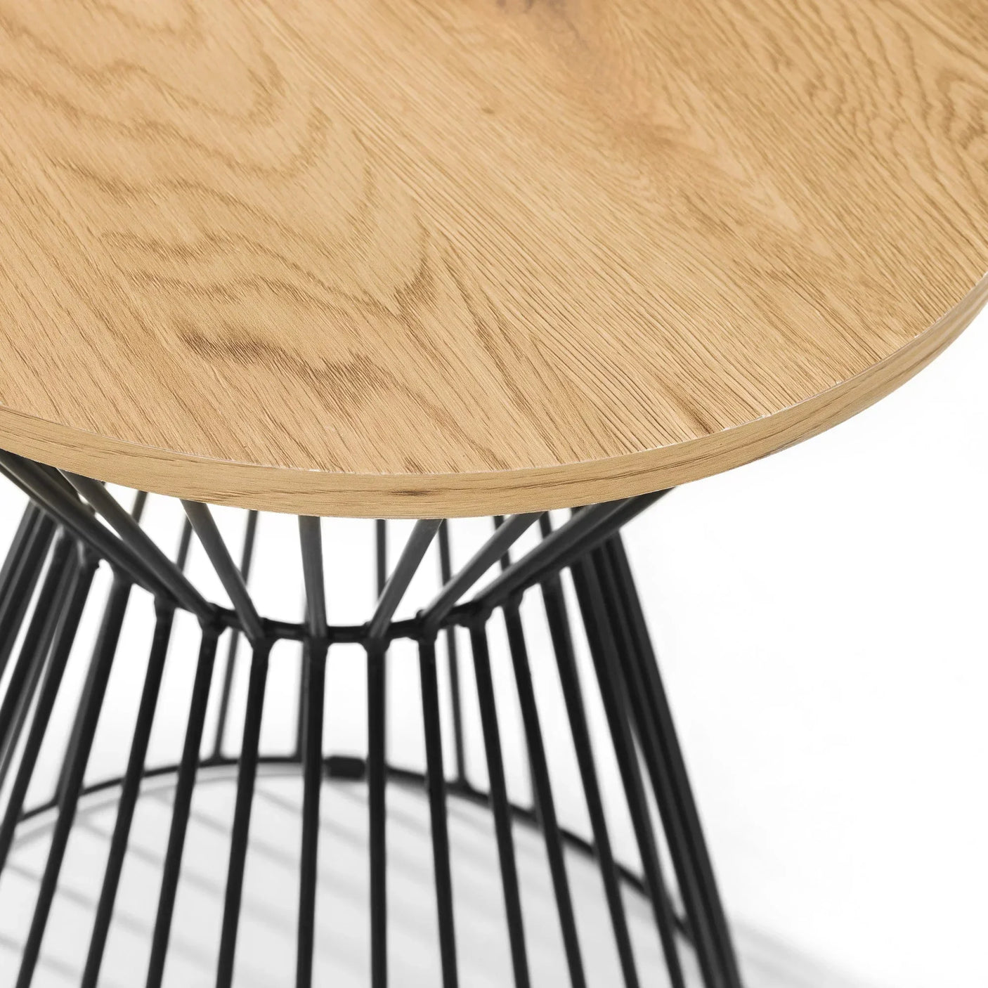 Round oak side table with black metal wire base, close-up of tabletop and frame