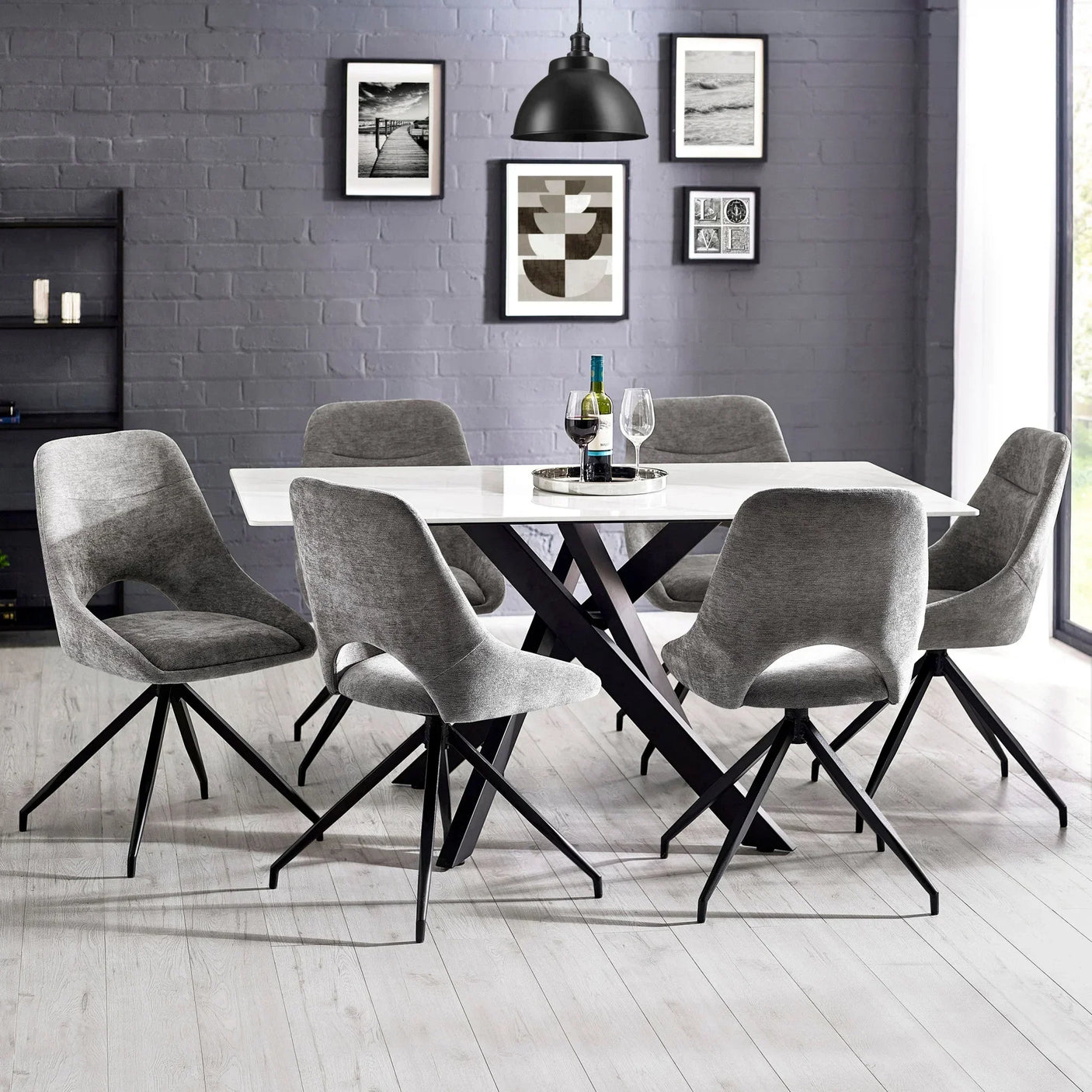 Modern dining table set with six grey swivel chairs and white top in bright dining room