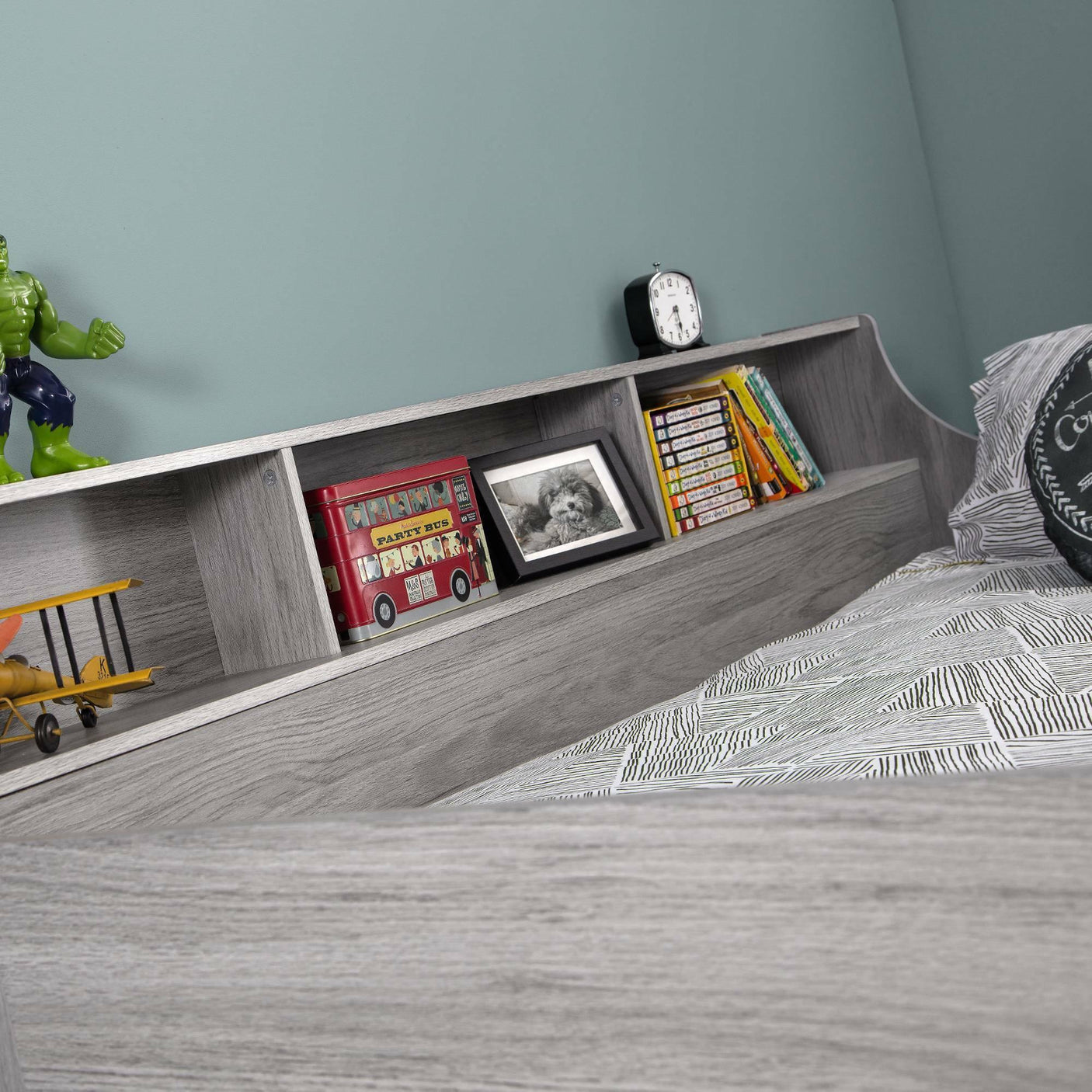 Jupiter midsleeper grey oak bed shelf with storage, toys, books, and alarm clock visible