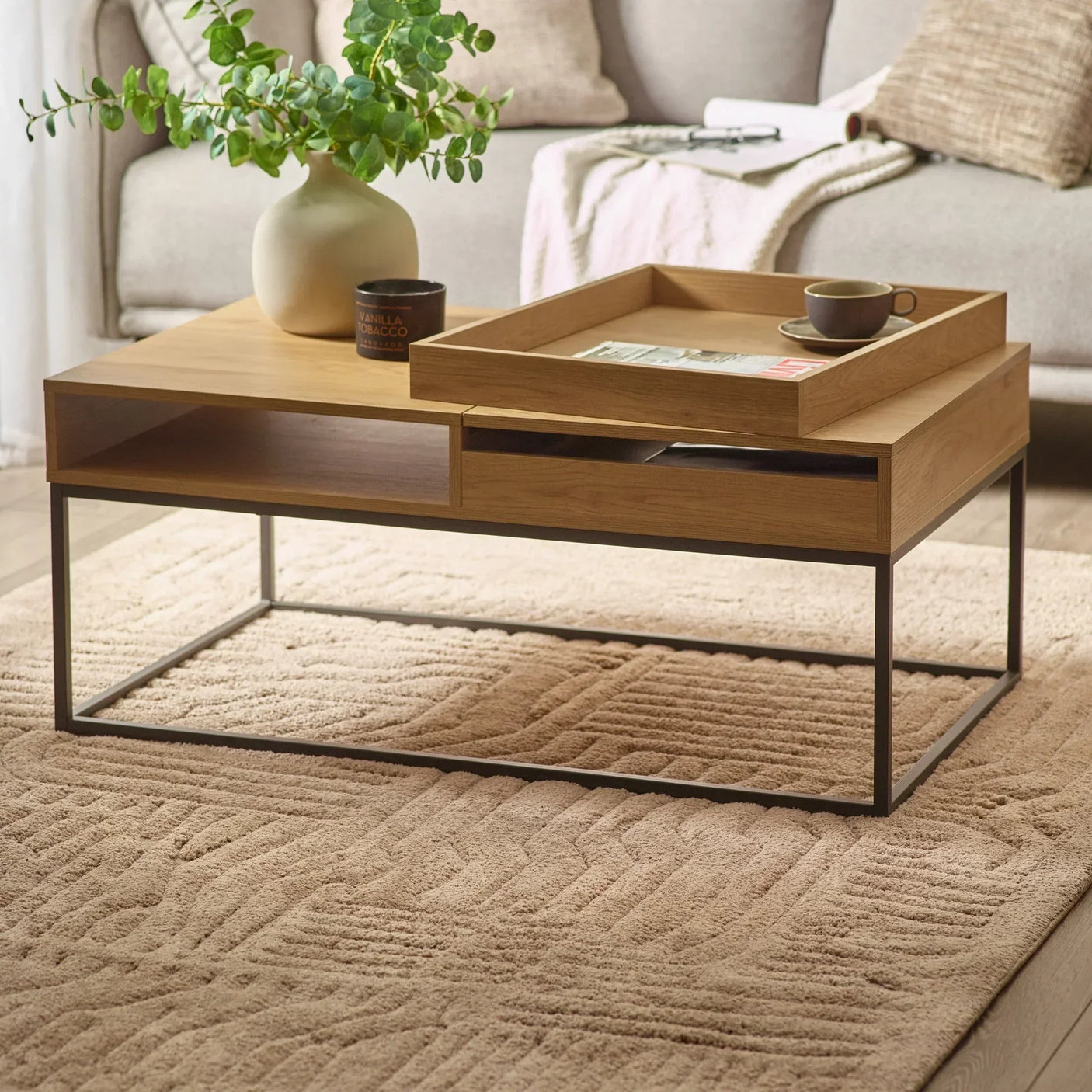 Wooden coffee table with metal frame, tray, and open shelves in modern living room