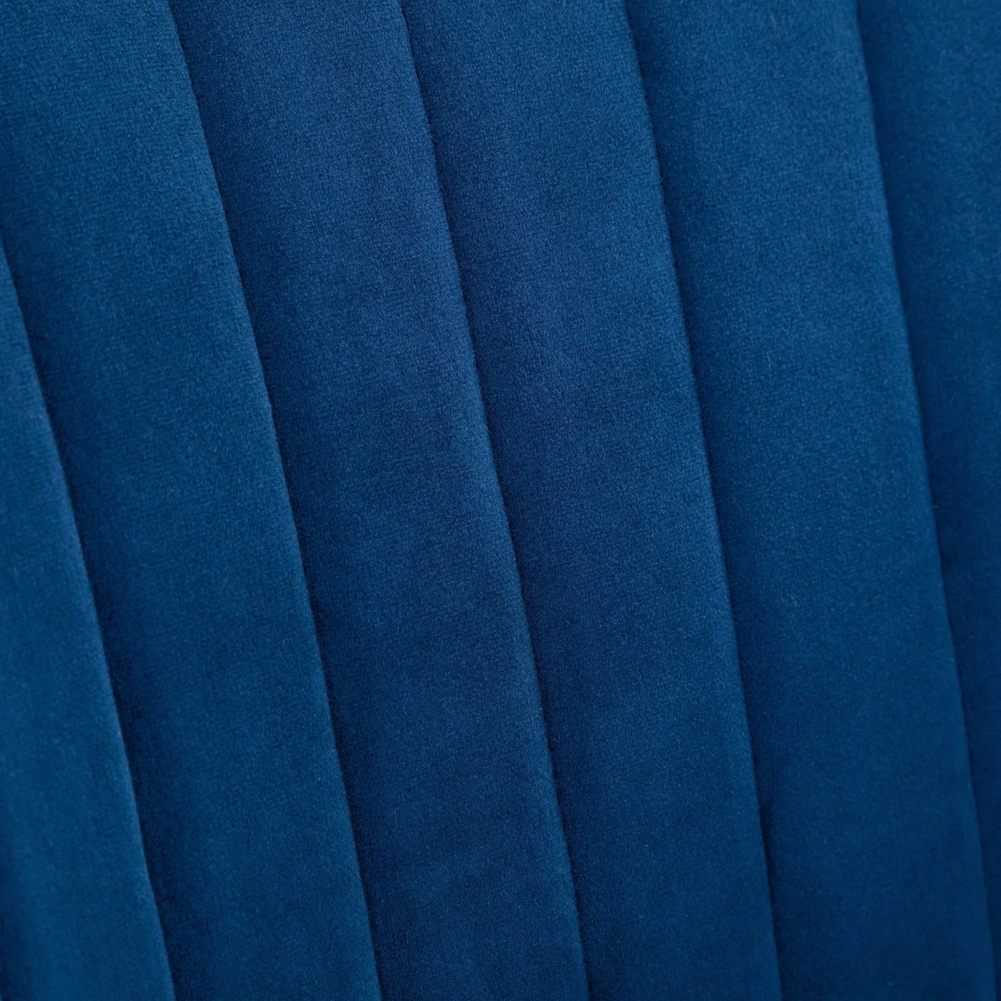 Close-up of blue office chair upholstery with vertical stitched panels