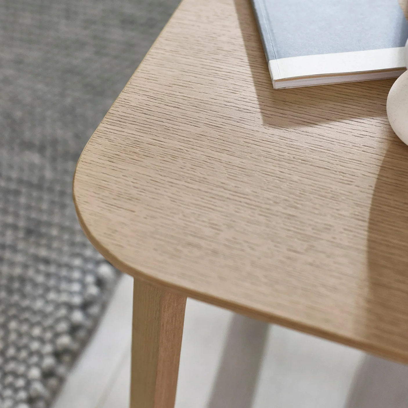 Oak side table corner detail with smooth finish and light wood grain