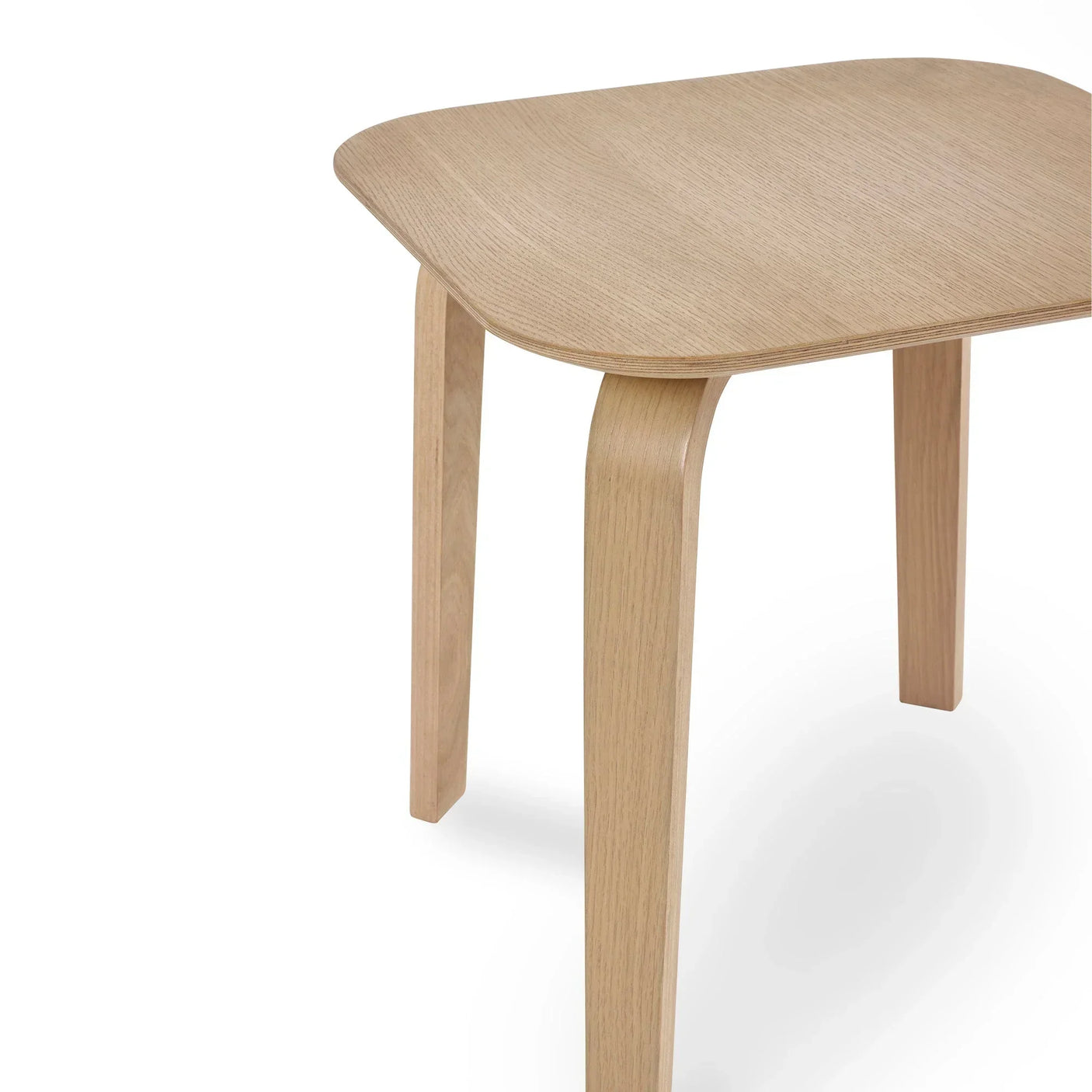 Light wood side table with curved legs and rounded corners, close-up detail view