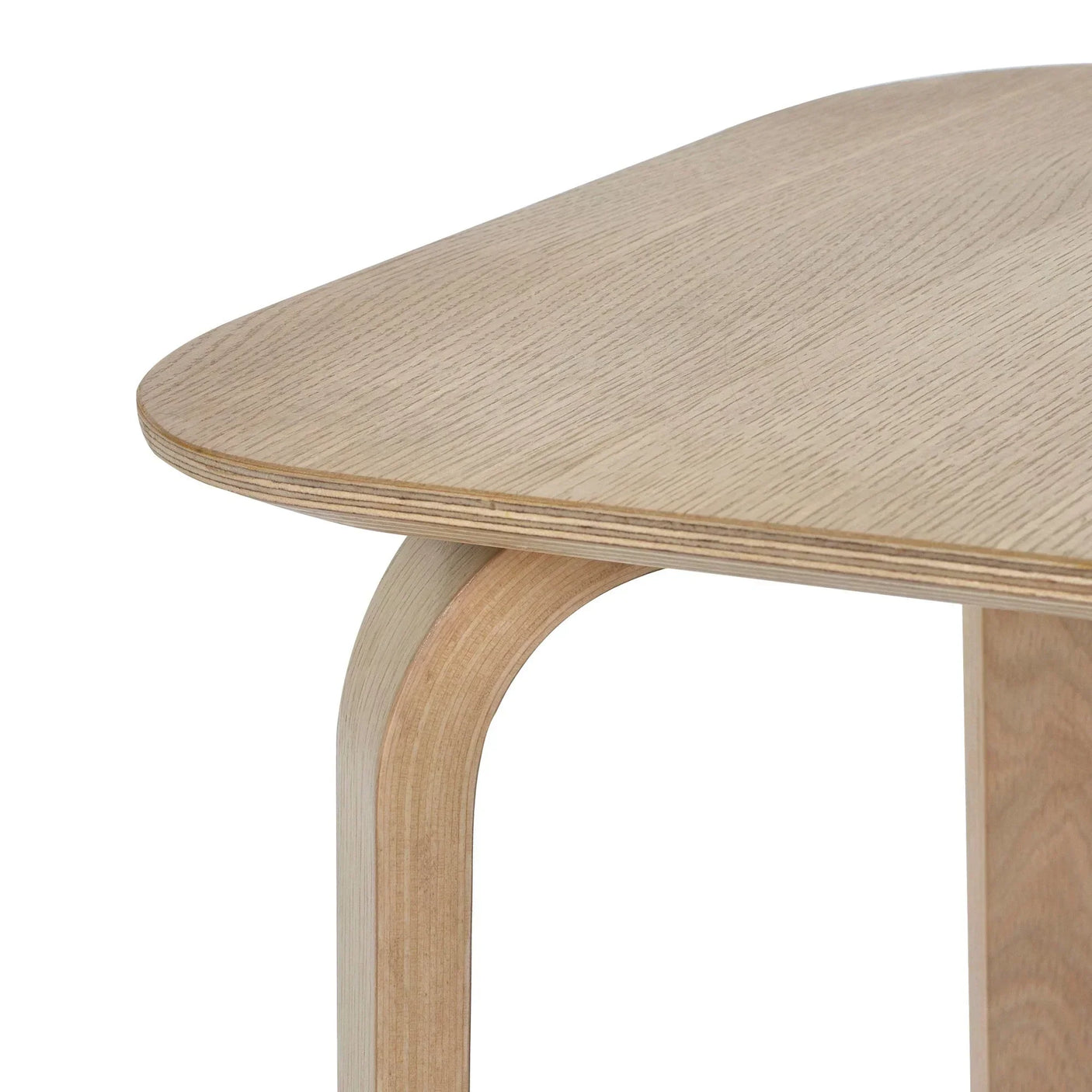Close-up of Kaito side table with light wood grain finish and curved leg detail