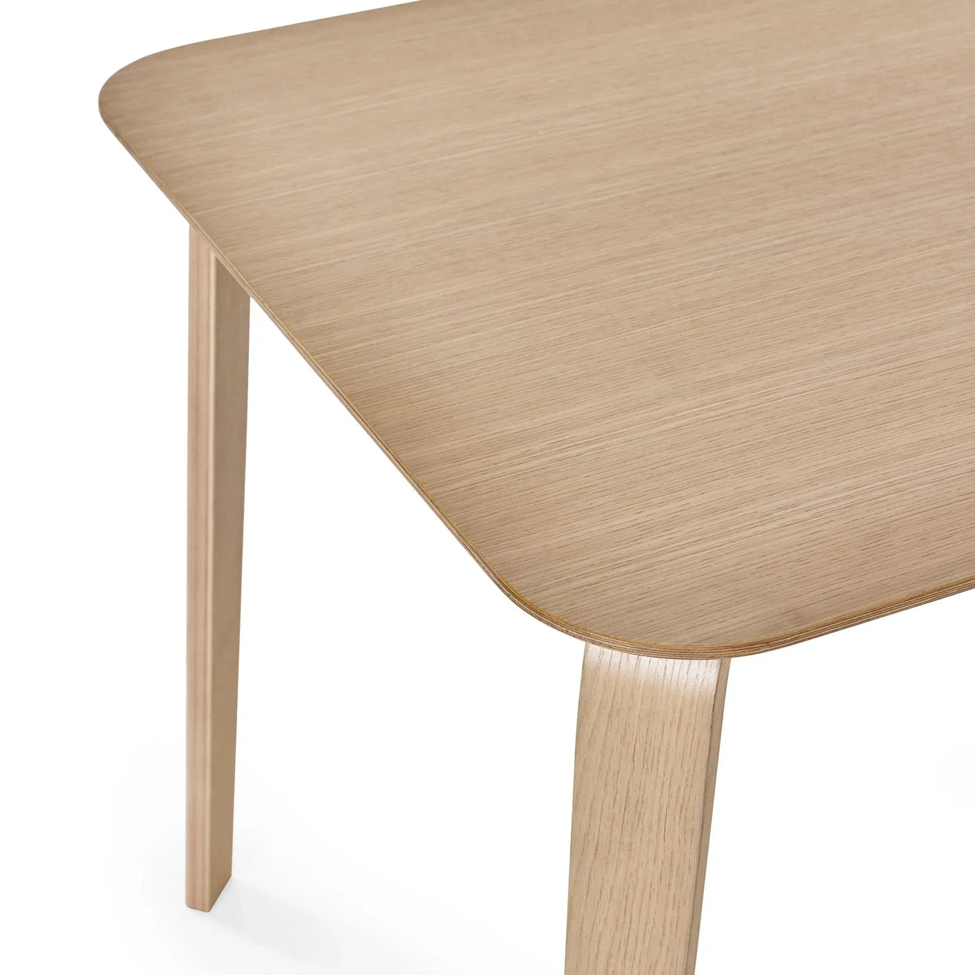 Oak veneer dining table corner with rounded edge and light wood grain finish