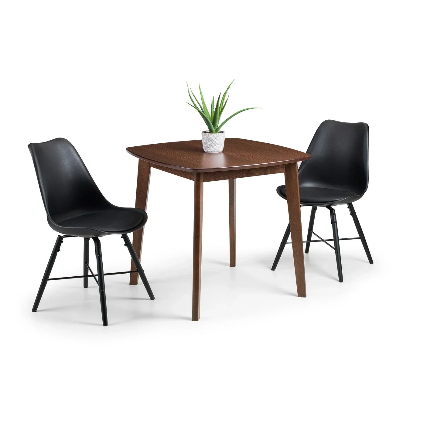 Black dining chairs with angled legs and a square wooden table, potted plant centered on top