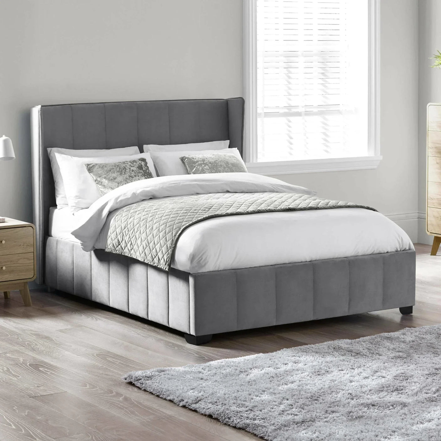 Grey upholstered bed with vertical panel headboard in modern bedroom setting