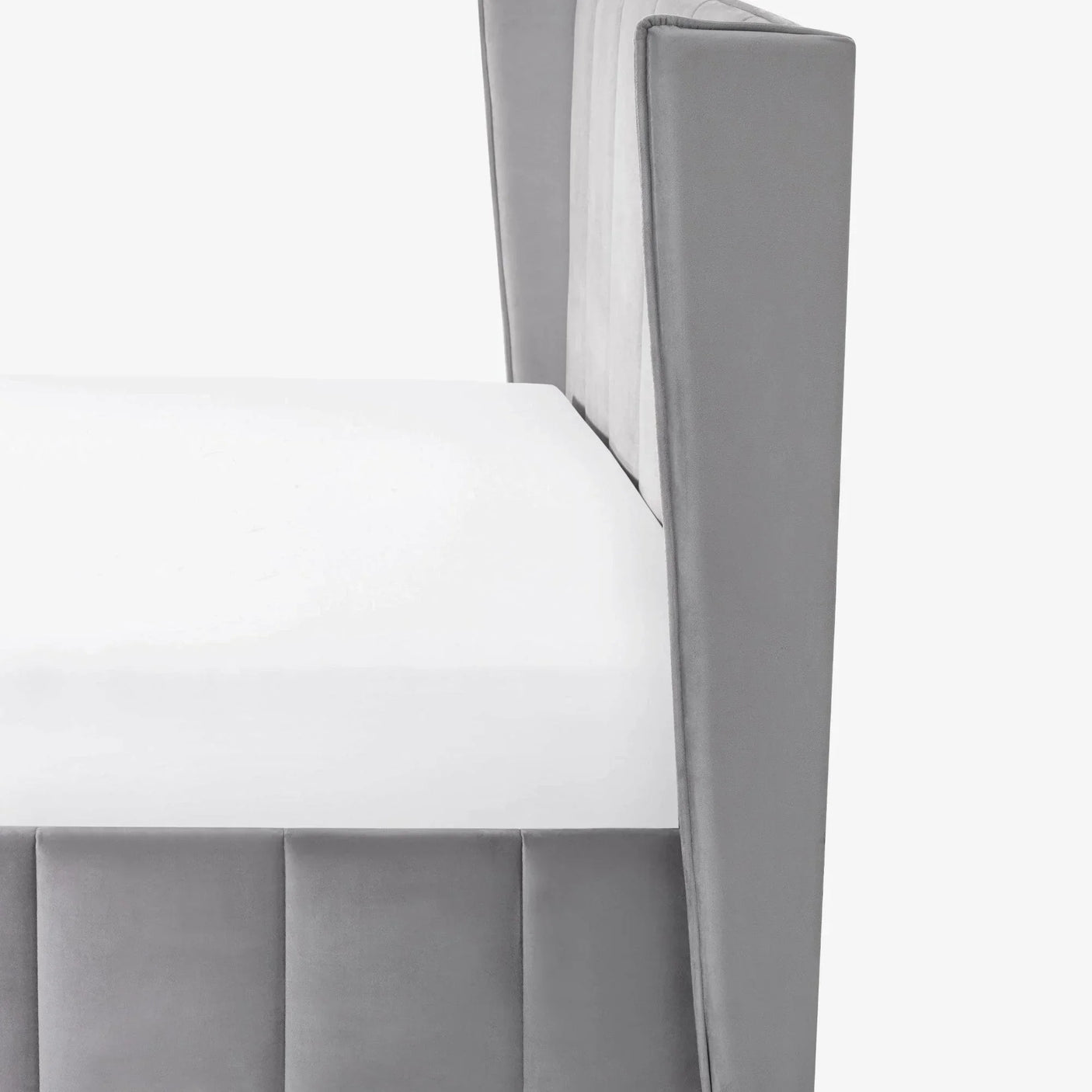 Grey upholstered bed frame side view with vertical panel headboard and white mattress