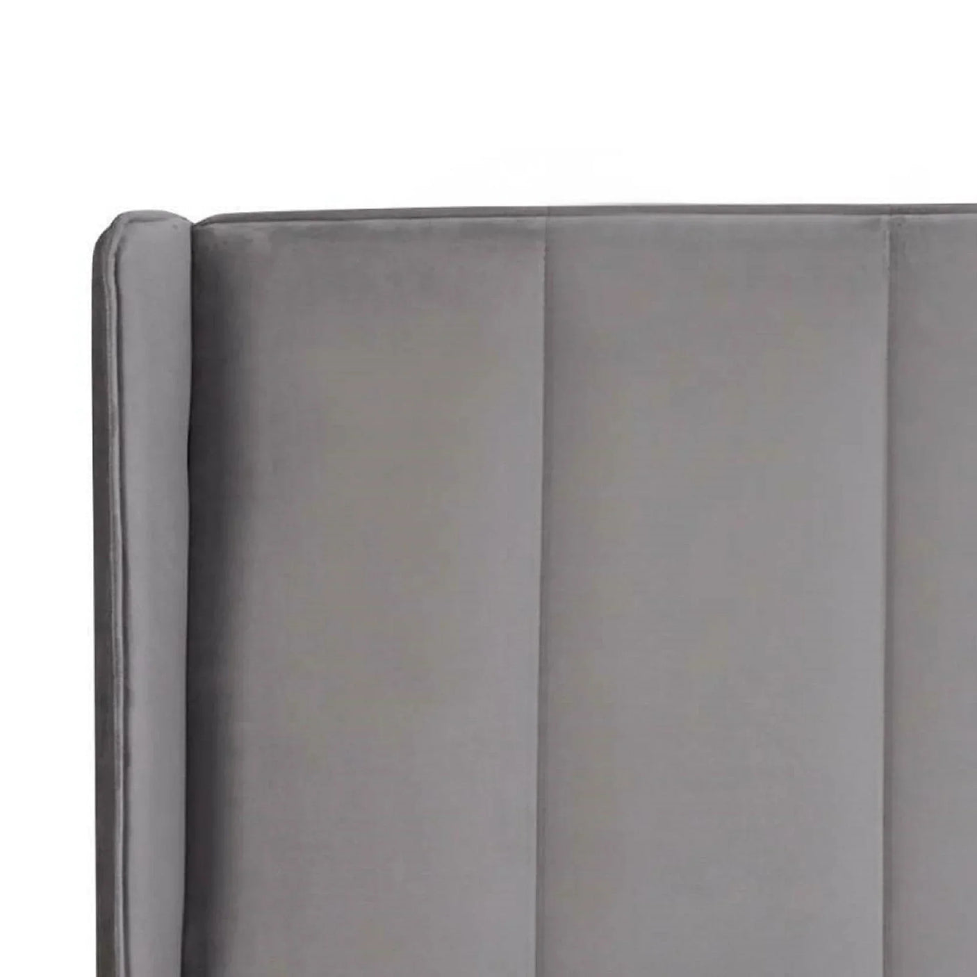Grey velvet bed headboard with vertical panel detail, close-up view of upholstery