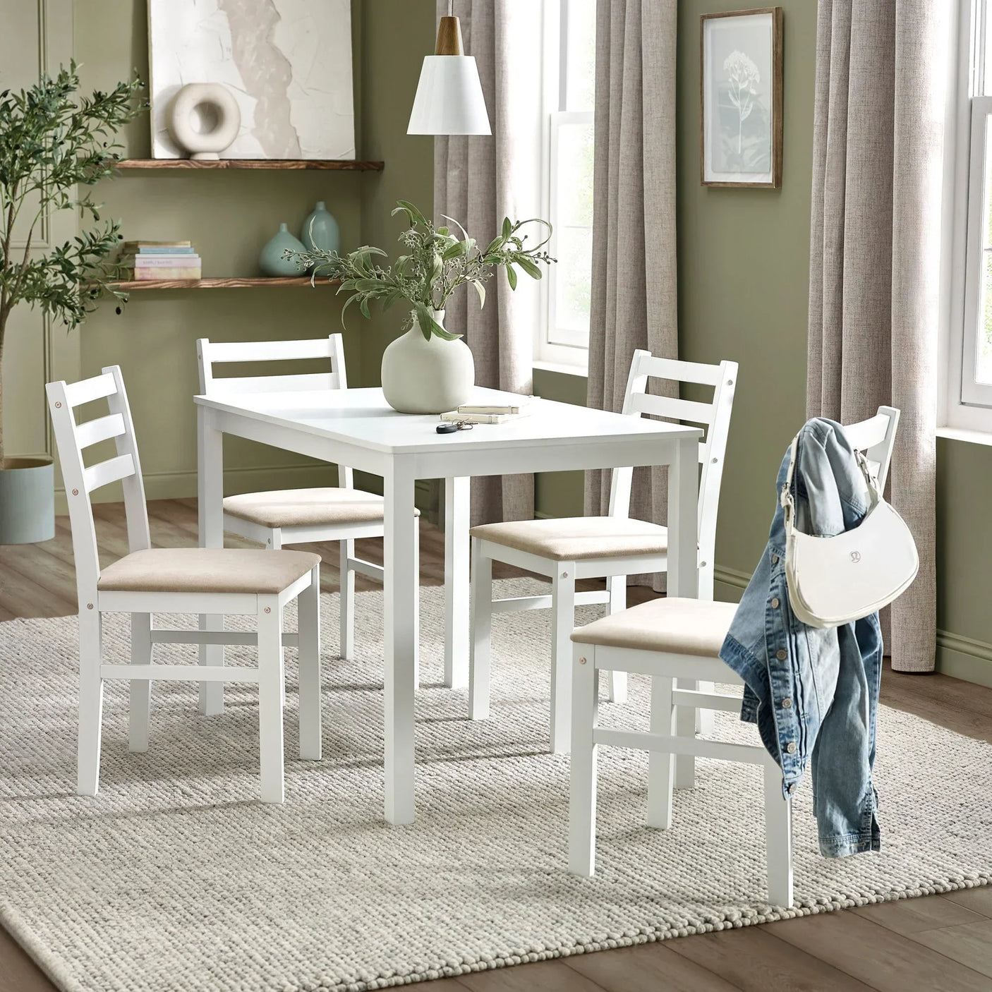 White dining table set with four chairs on neutral rug in modern dining room