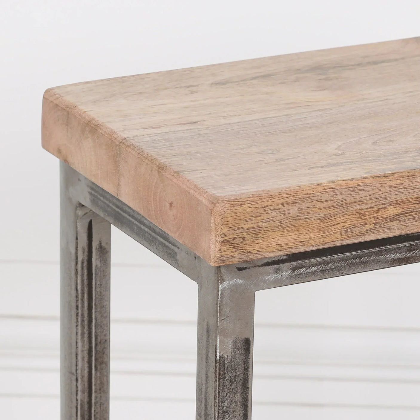 Closeup of industrial side table with solid oak top and metal legs