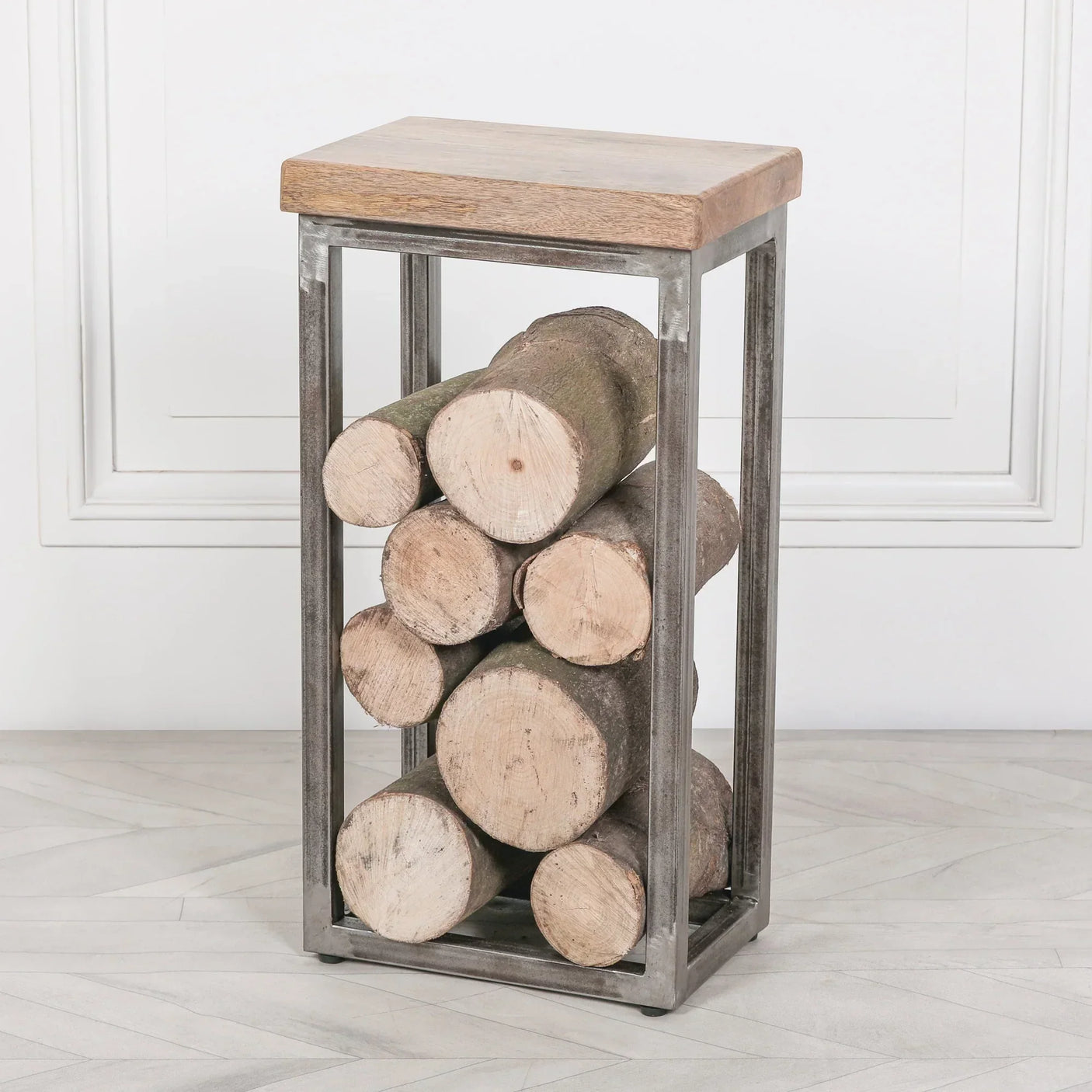 Industrial log holder with metal frame and wooden top filled with cut firewood logs