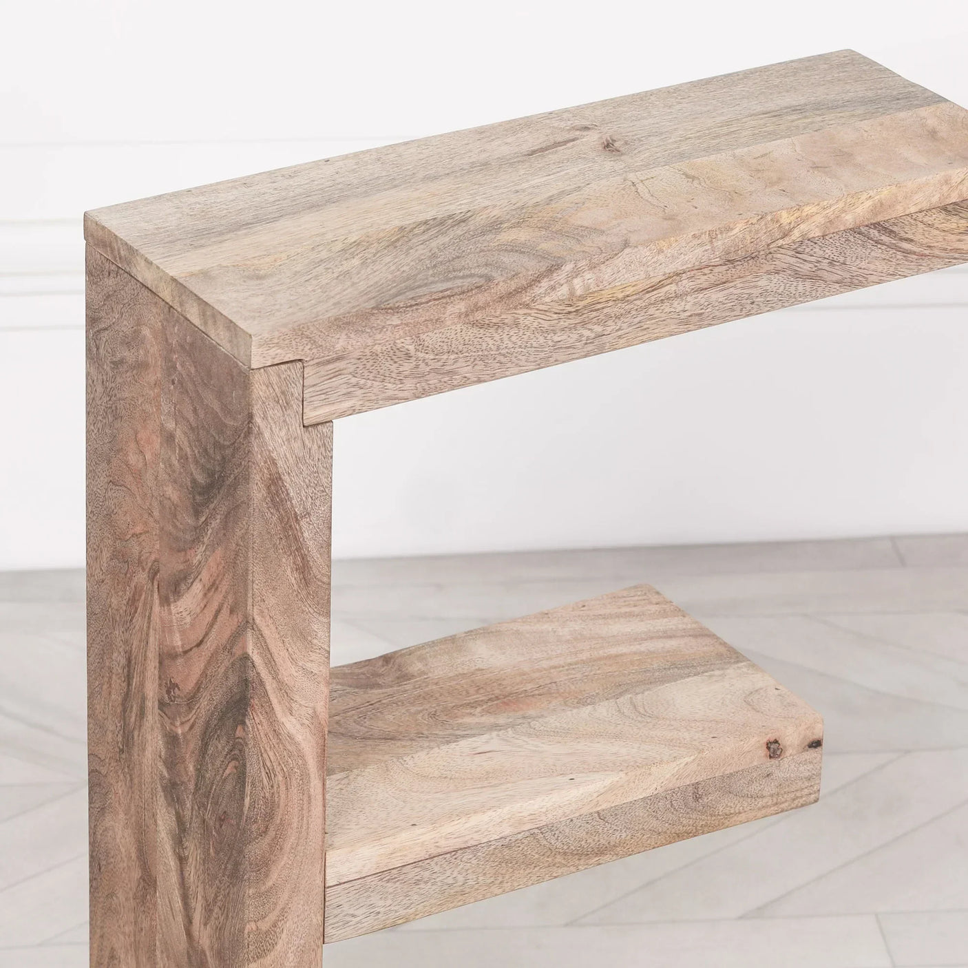 Rustic mango wood side table with open shelf and light natural finish, close-up view