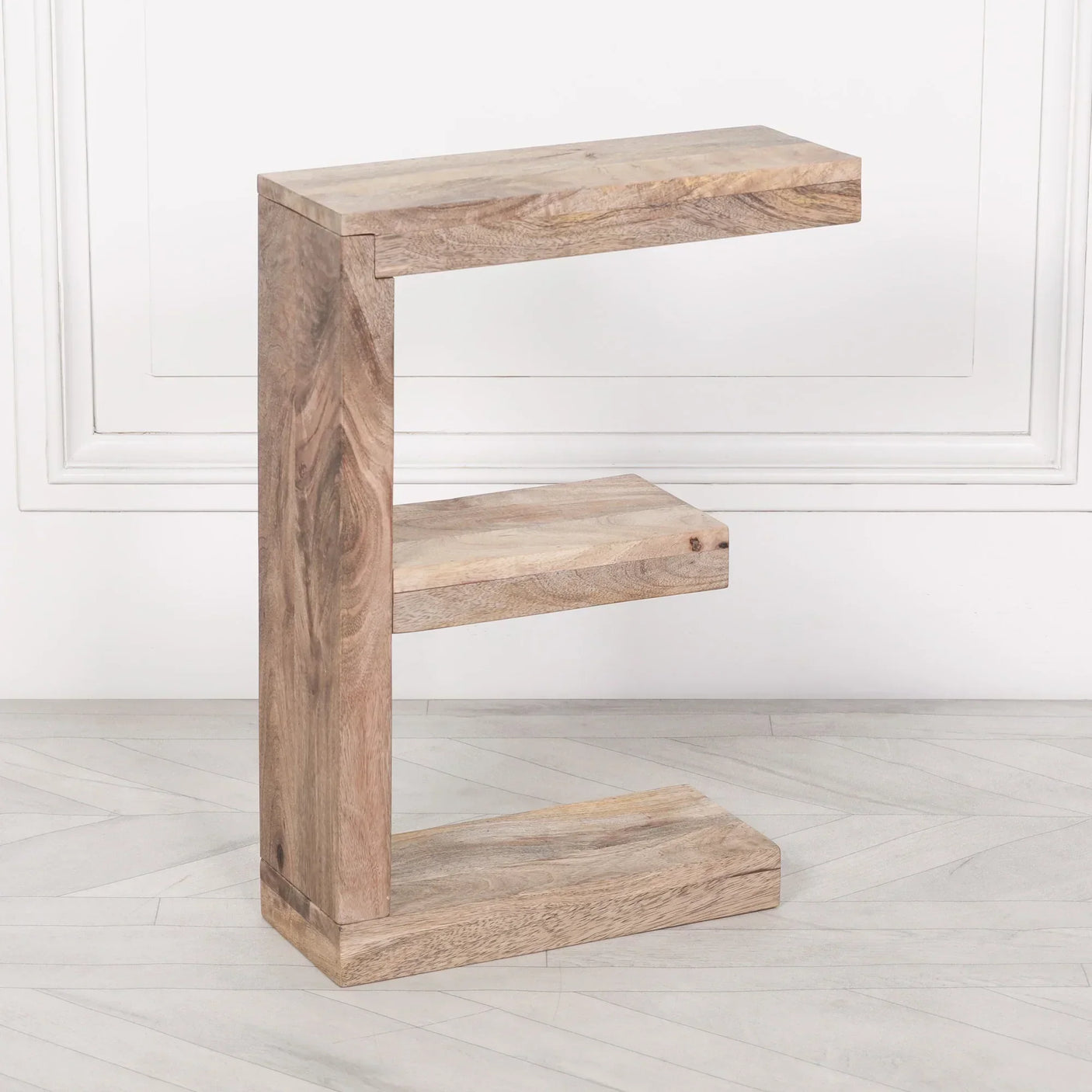Mango wood side table with natural finish and open shelves in modern C shape design