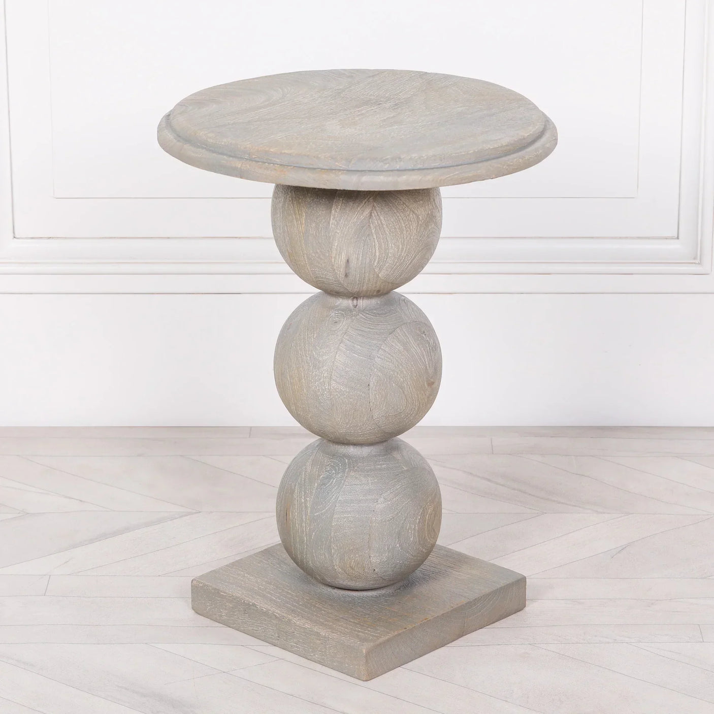 Light grey wooden side table with round stacked sphere base and square bottom