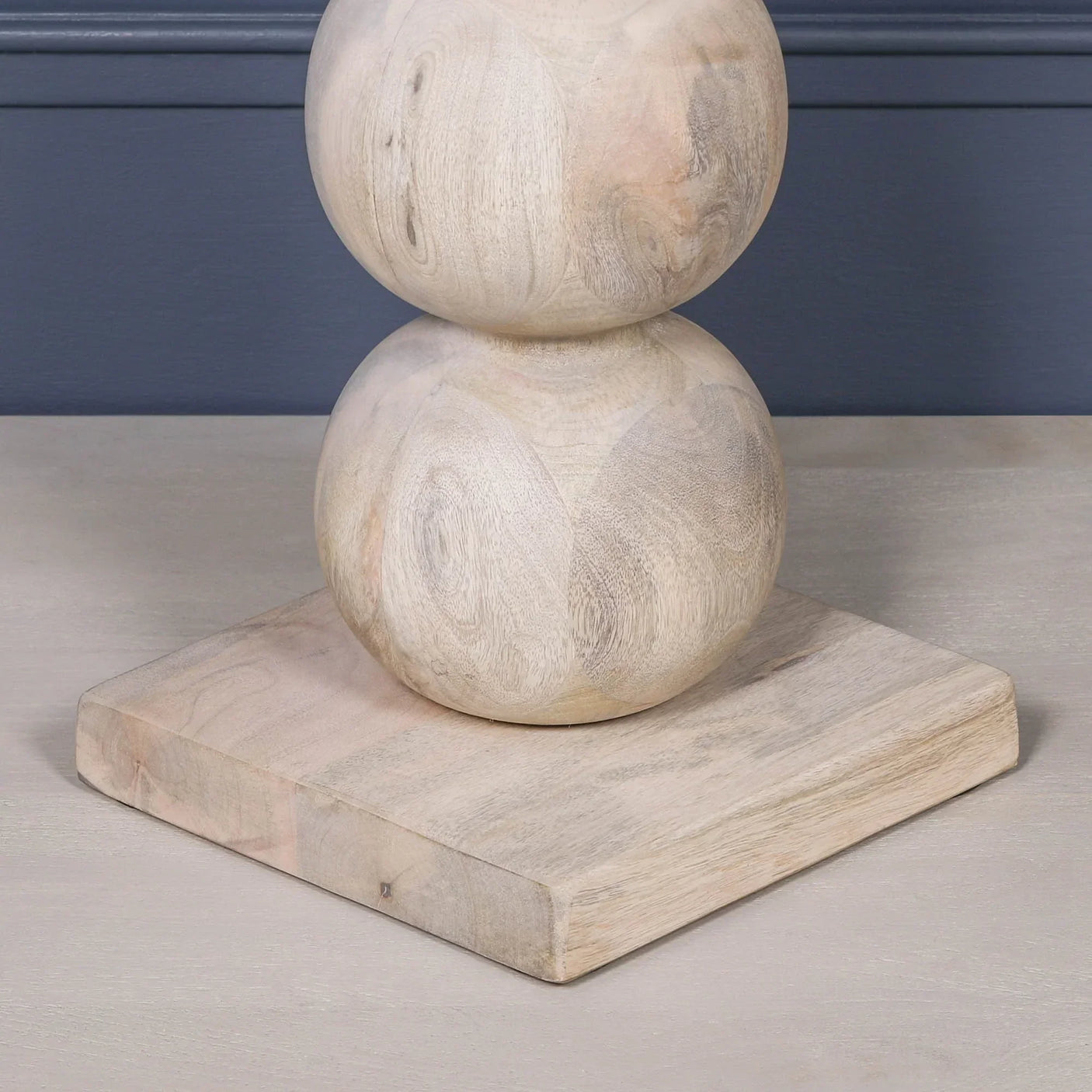 Natural wood furniture base with round stacked shapes and square platform detail