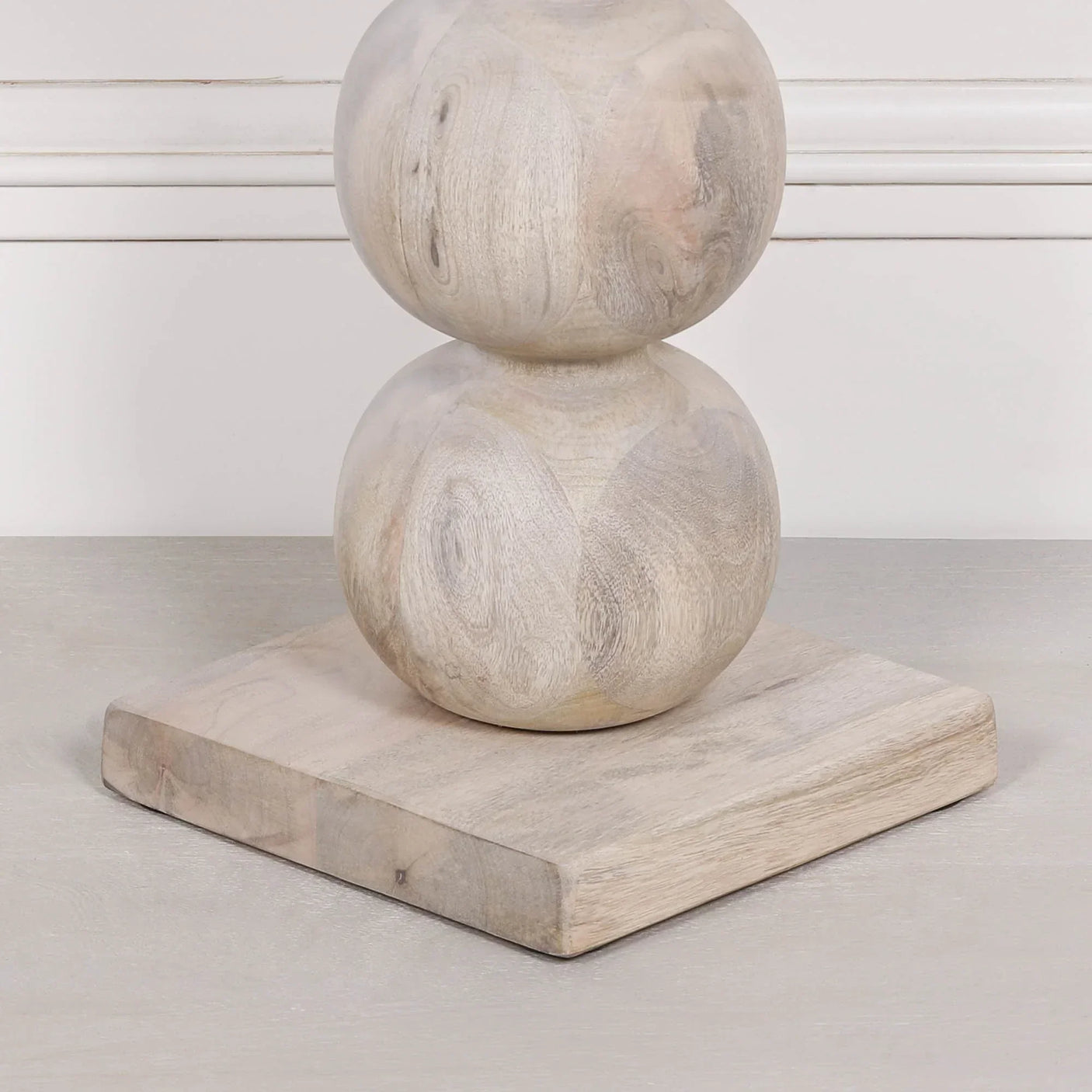 Carved wood ornament with stacked spheres on square base, light natural finish