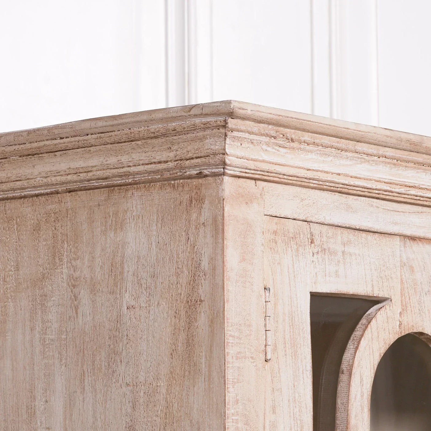 Distressed wood cabinet corner with glass door and rustic finish