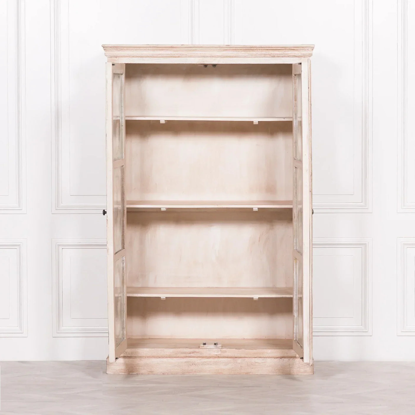 Rustic wooden display cabinet with glass doors and three shelves, open against white wall