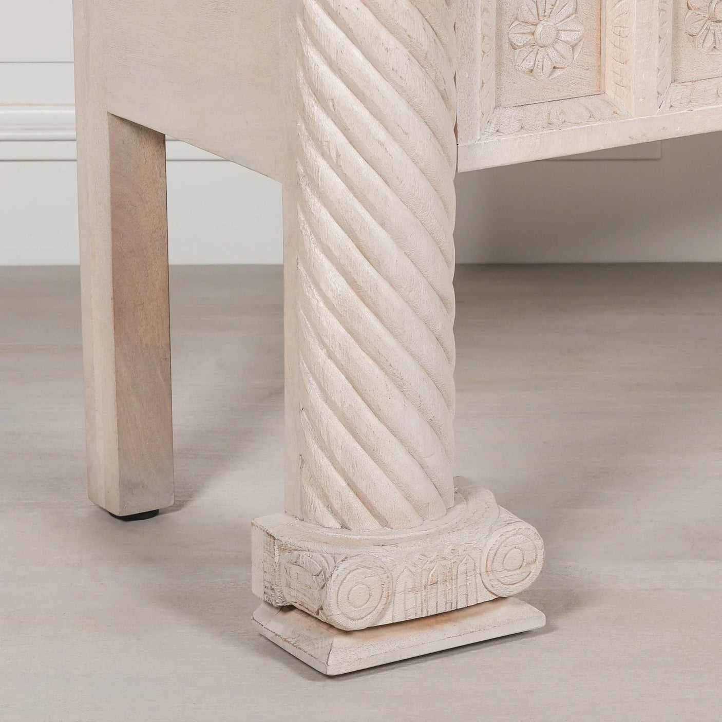 Carved wood furniture leg with spiral column detail and ornate floral pattern