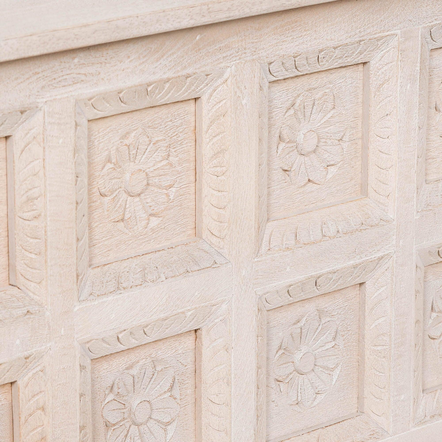 Light wood chest panel with carved floral detailing and textured finish
