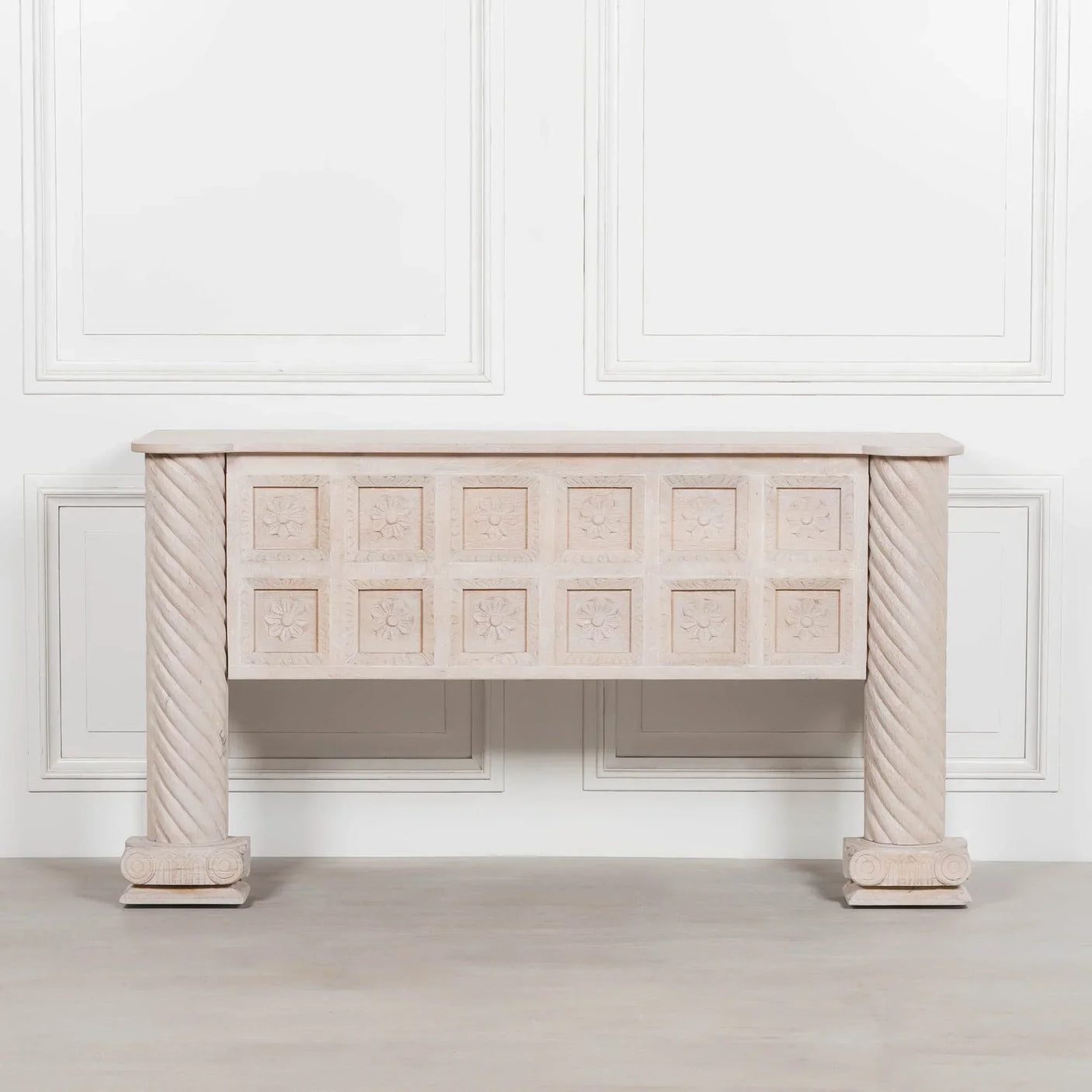 Carved wood console table with twisted columns and floral patterned drawer fronts