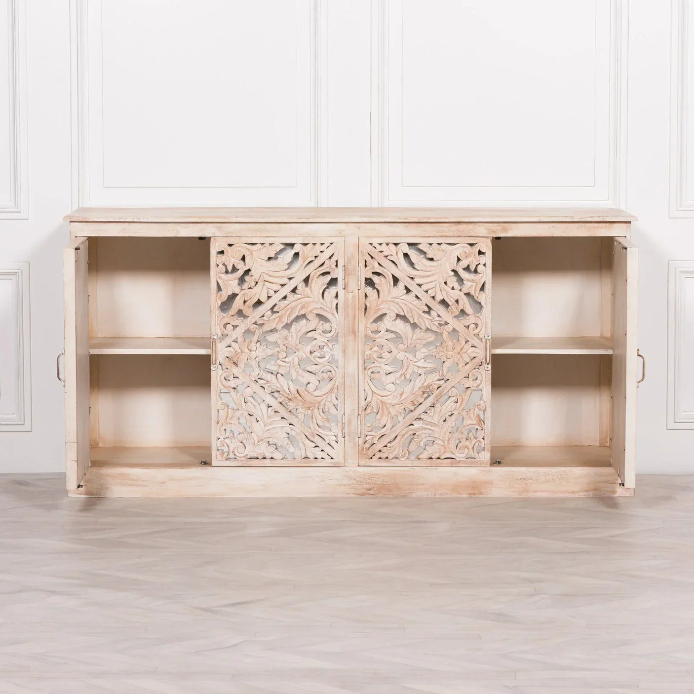 Carved wooden sideboard with sliding doors and open shelving in distressed light wood finish