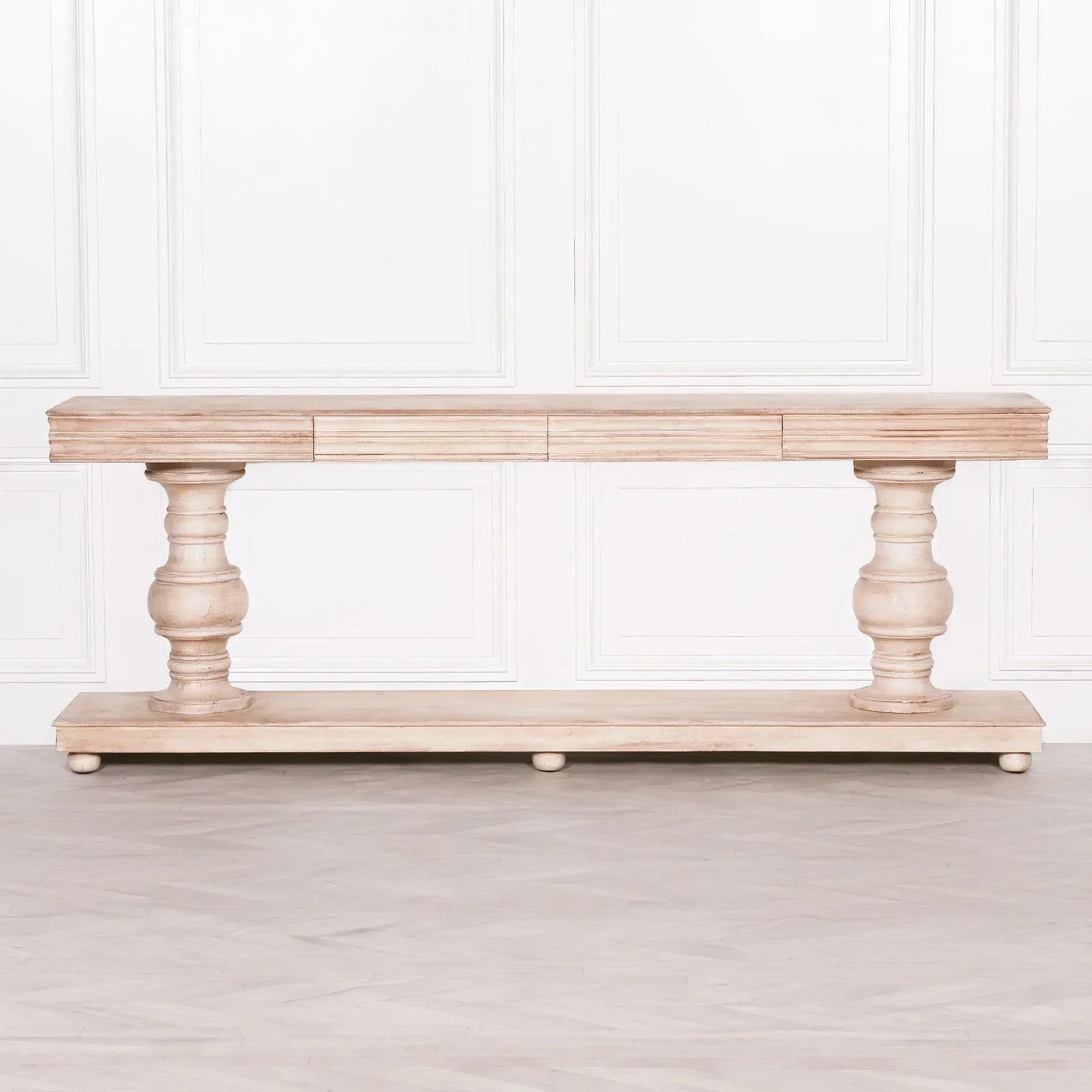 Rustic wooden console table with turned legs and natural finish against white panel wall