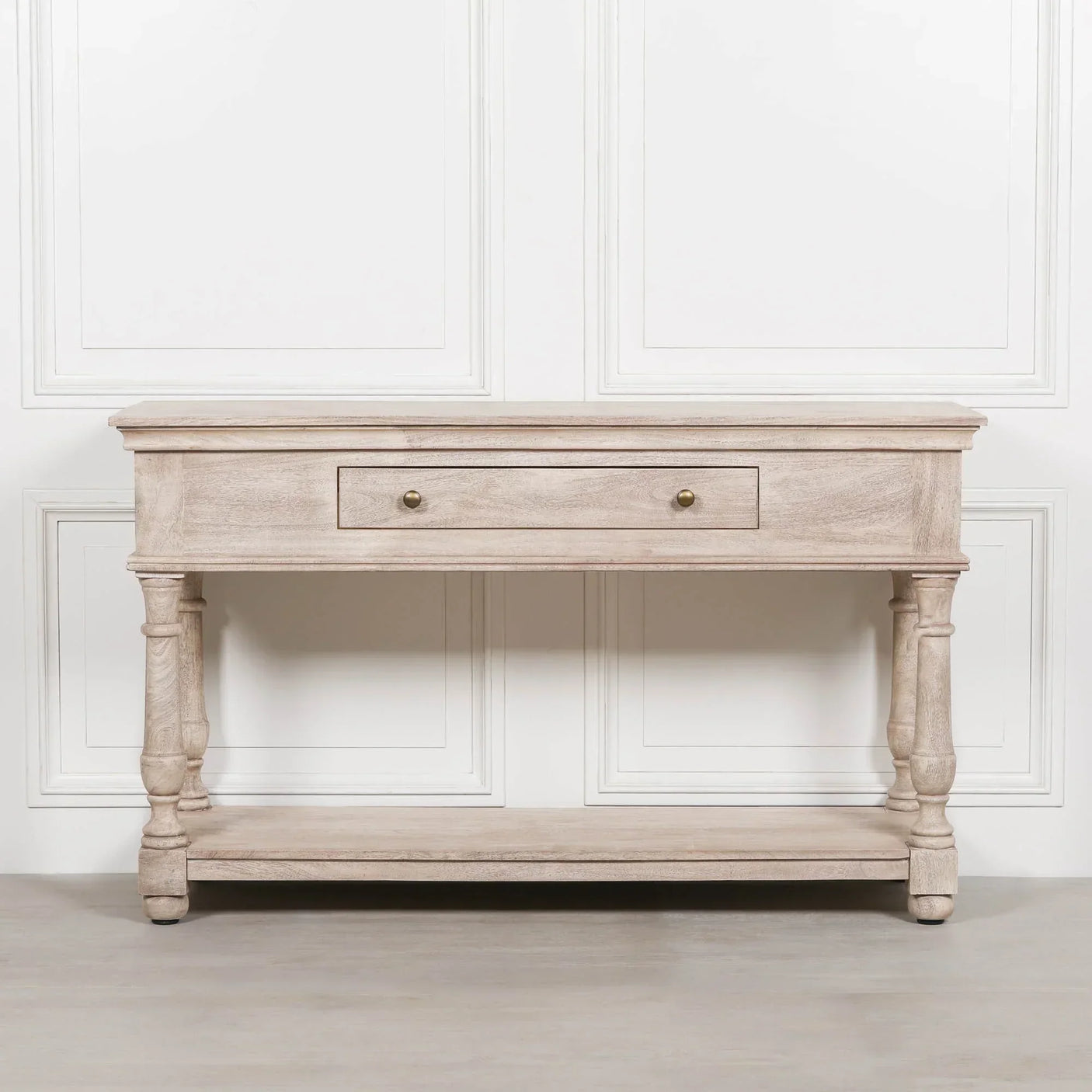 Light wood console table with single drawer, turned legs and lower shelf, front view