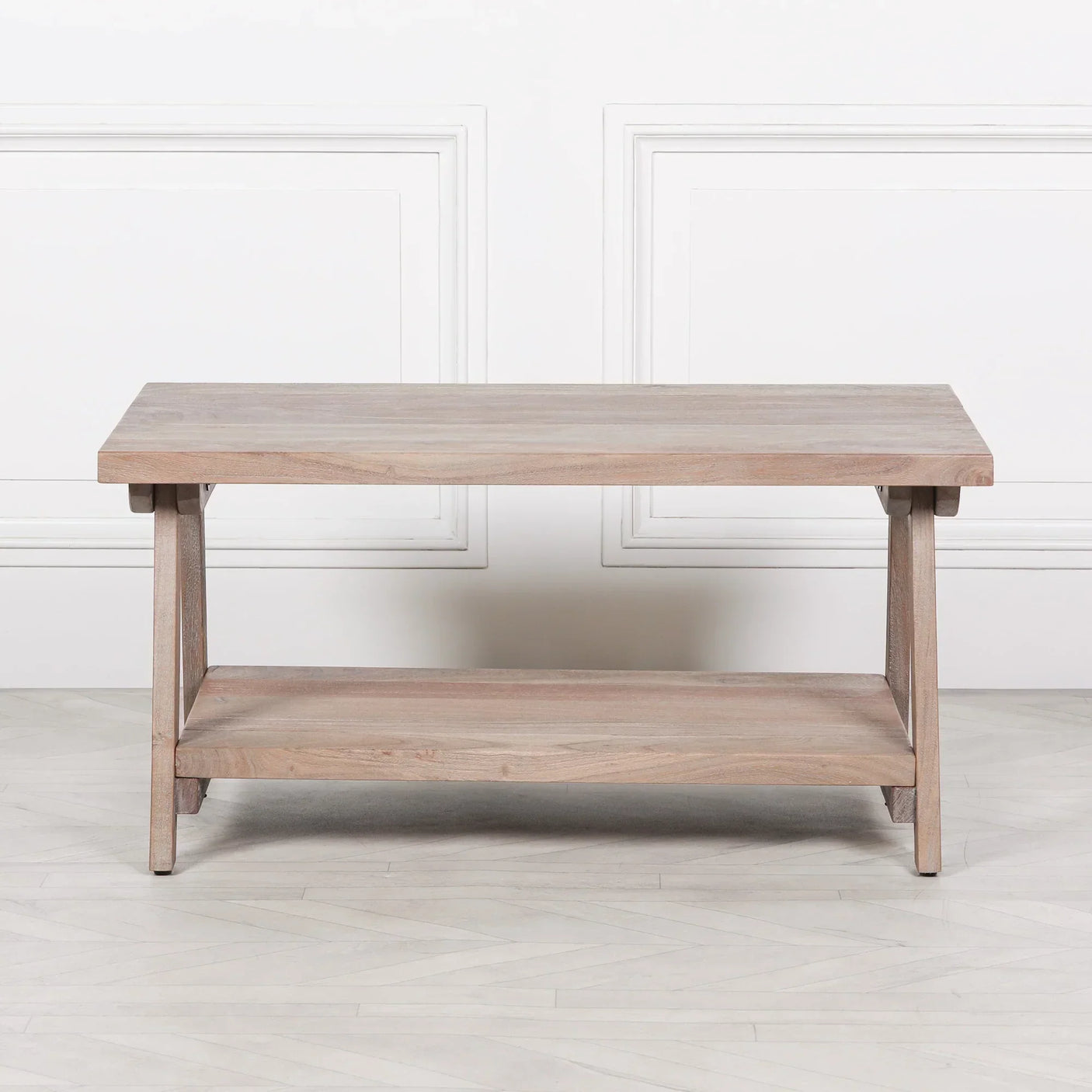 Light wood coffee table with shelf and clean rectangular design against white wall