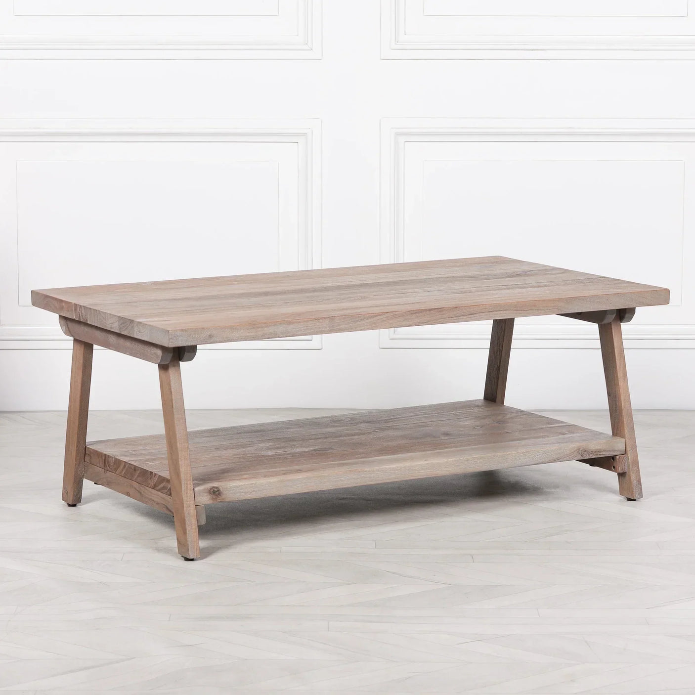 Light wood coffee table with lower shelf and angled legs on laminate floor