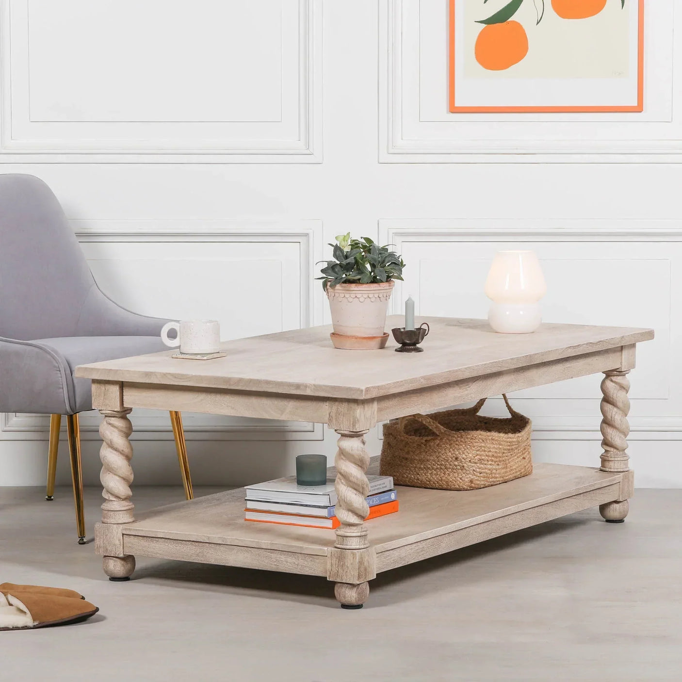 Light wood coffee table with twisted legs, lower shelf, books, and decor in a modern living room