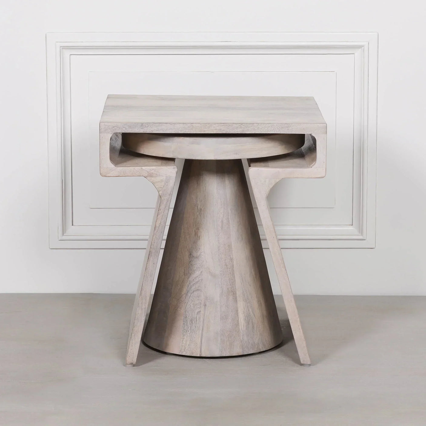 Light wood side table with modern geometric design on neutral background