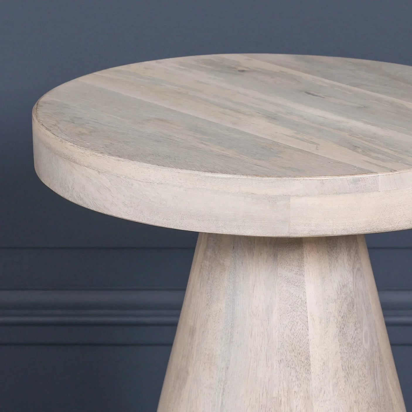 Round light wood side table with smooth finish and tapered pedestal base